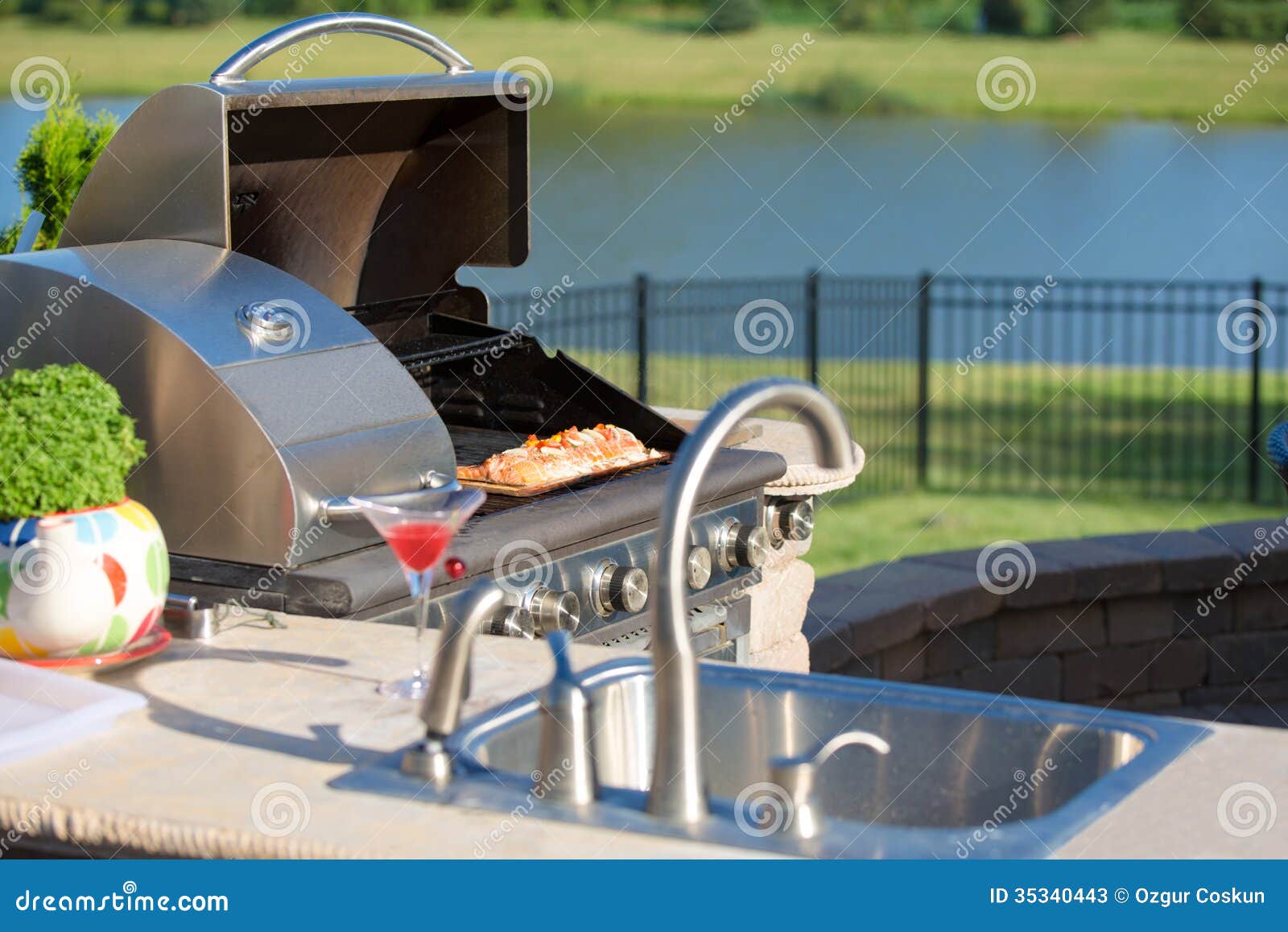 cooking cedar salmon on the barbecue at the outdoor kitchen