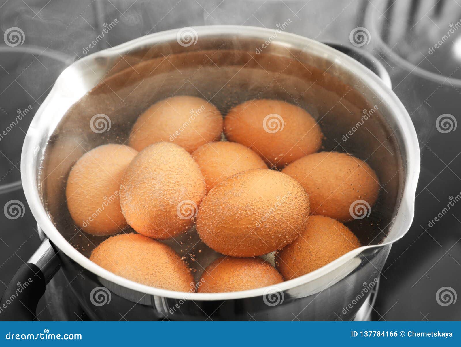 Cooking Chicken Eggs in Pot on Electric Stove, Closeup Stock Photo