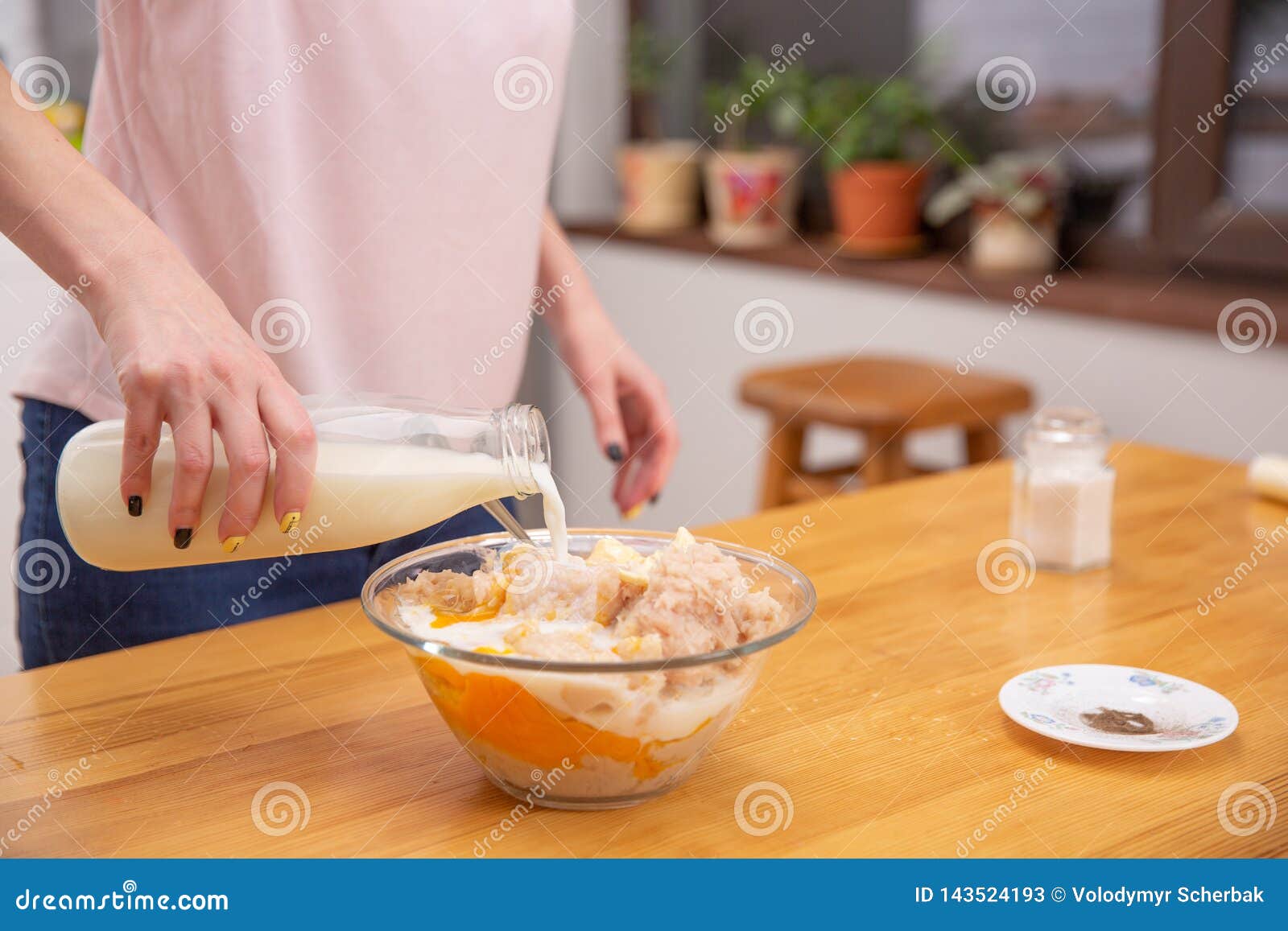 cooking chicken sausages. pouring milk to minced chicken