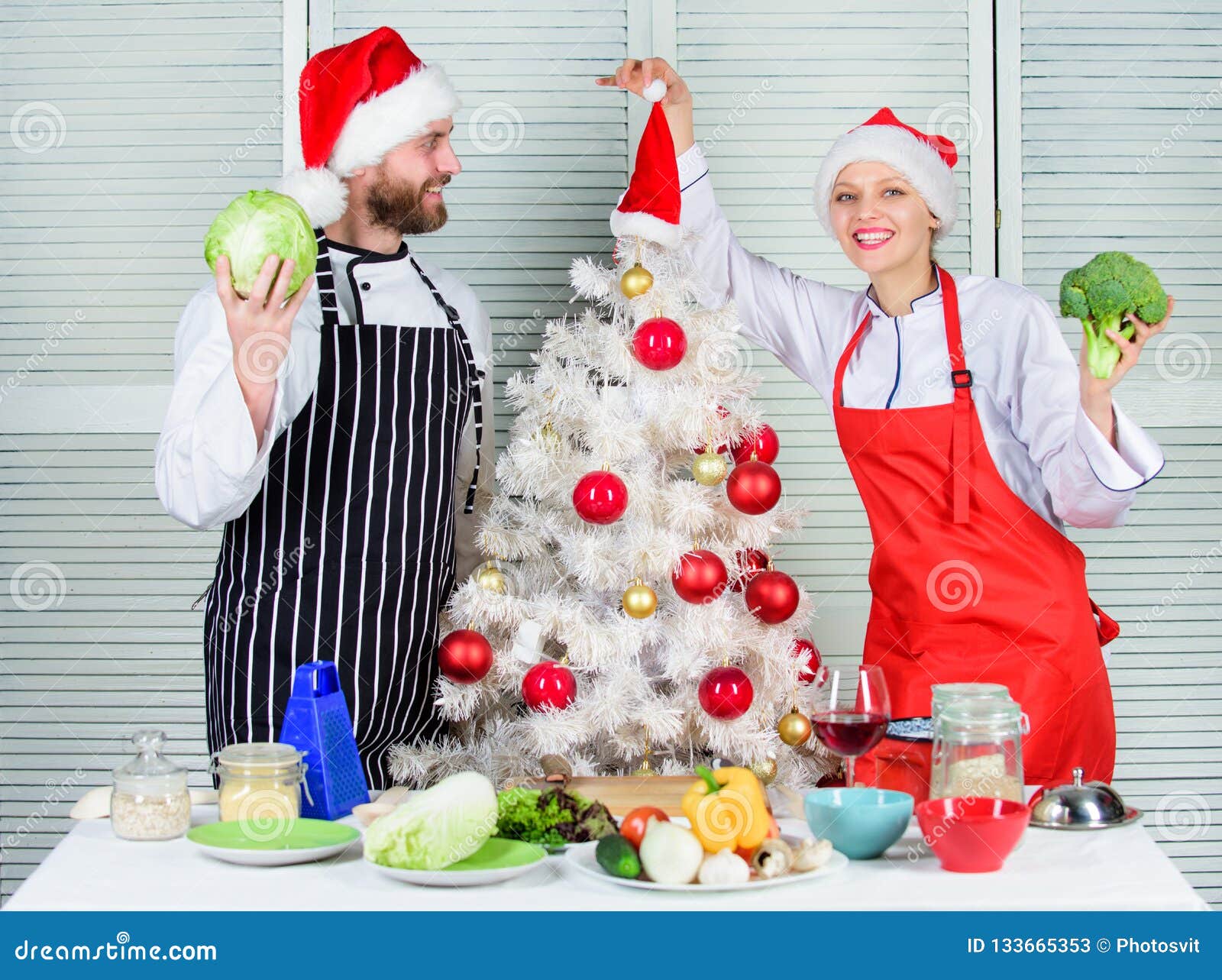 Cooking Christmas Meal. Man and Woman Chef Santa Hat Near Christmas ...
