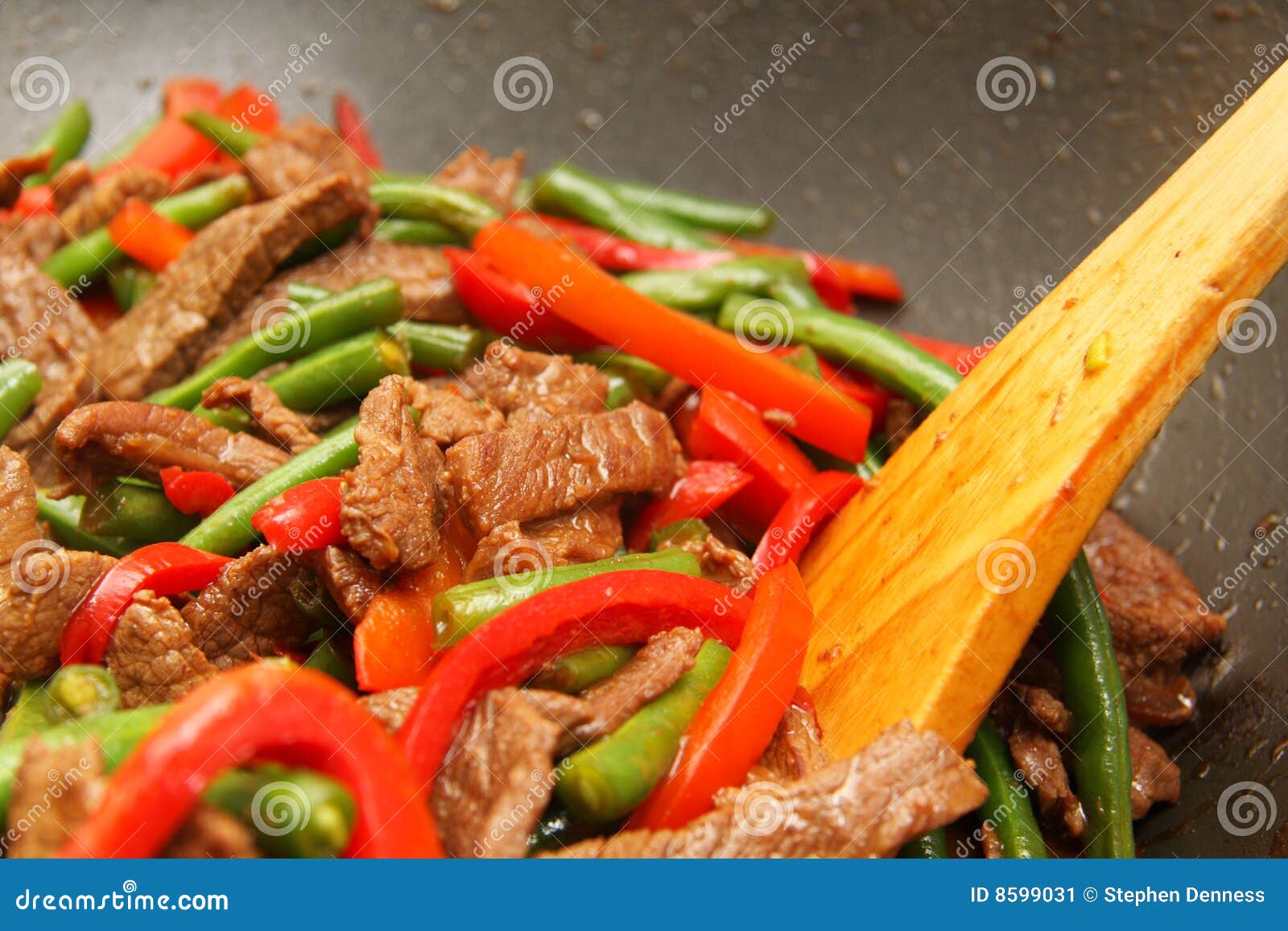 cooking delicious beef, bean, capsicum stir-fry