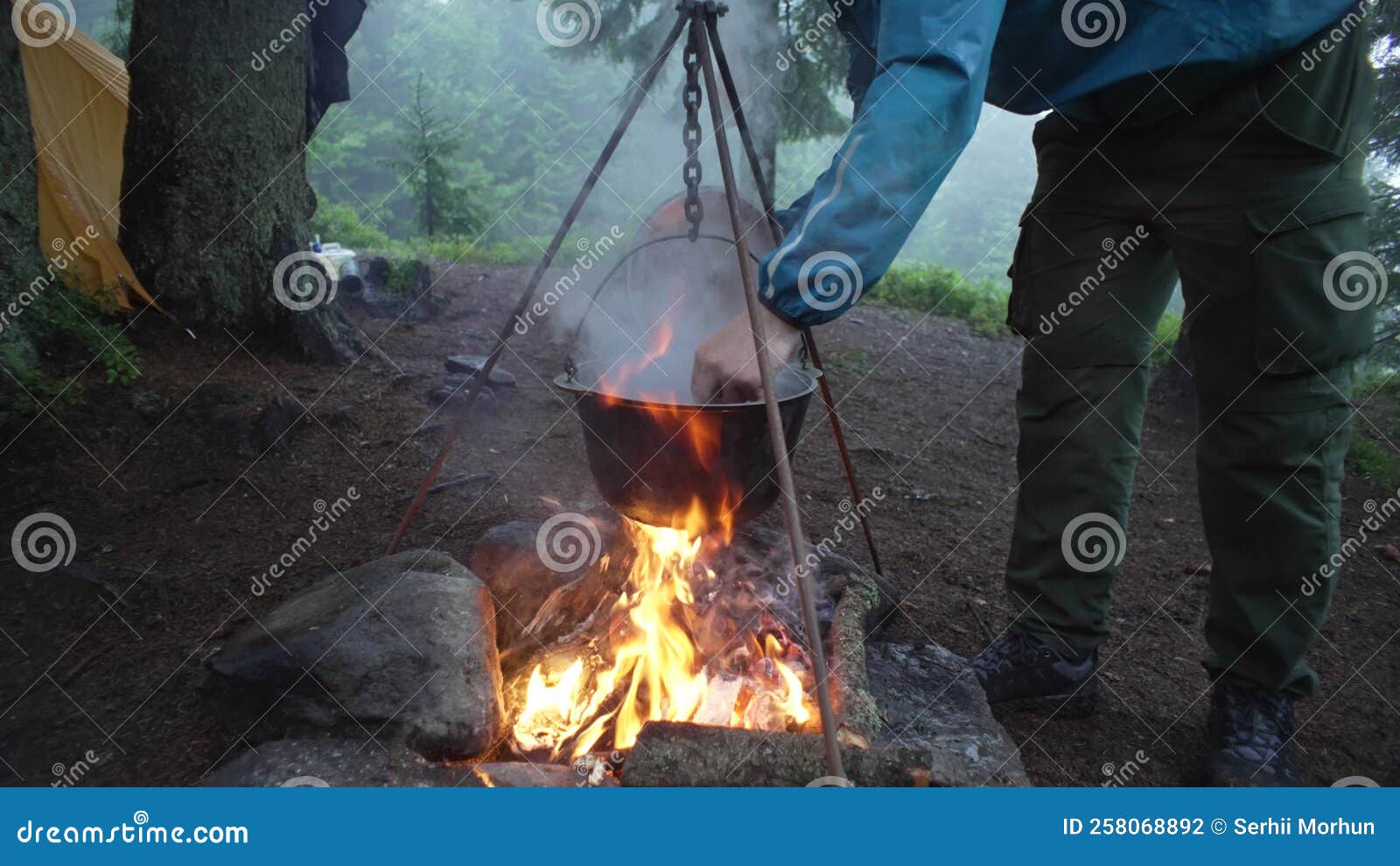 Cooking on a Fire in the Forest during the Rain. Cooking on a Camping