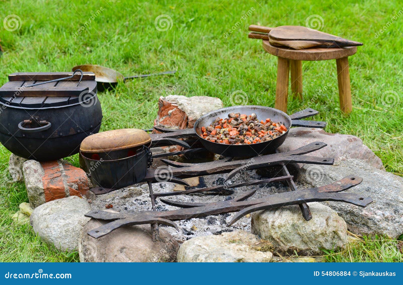 Cooking on fire outdoors stock photo. Image of frying 54806884