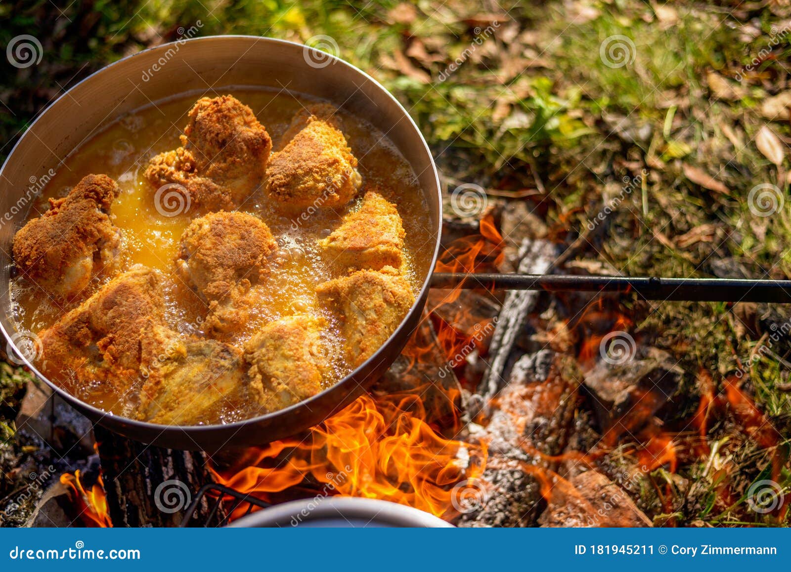 Cooking Food Over Open Fire while Camping on an Adventure Stock Image