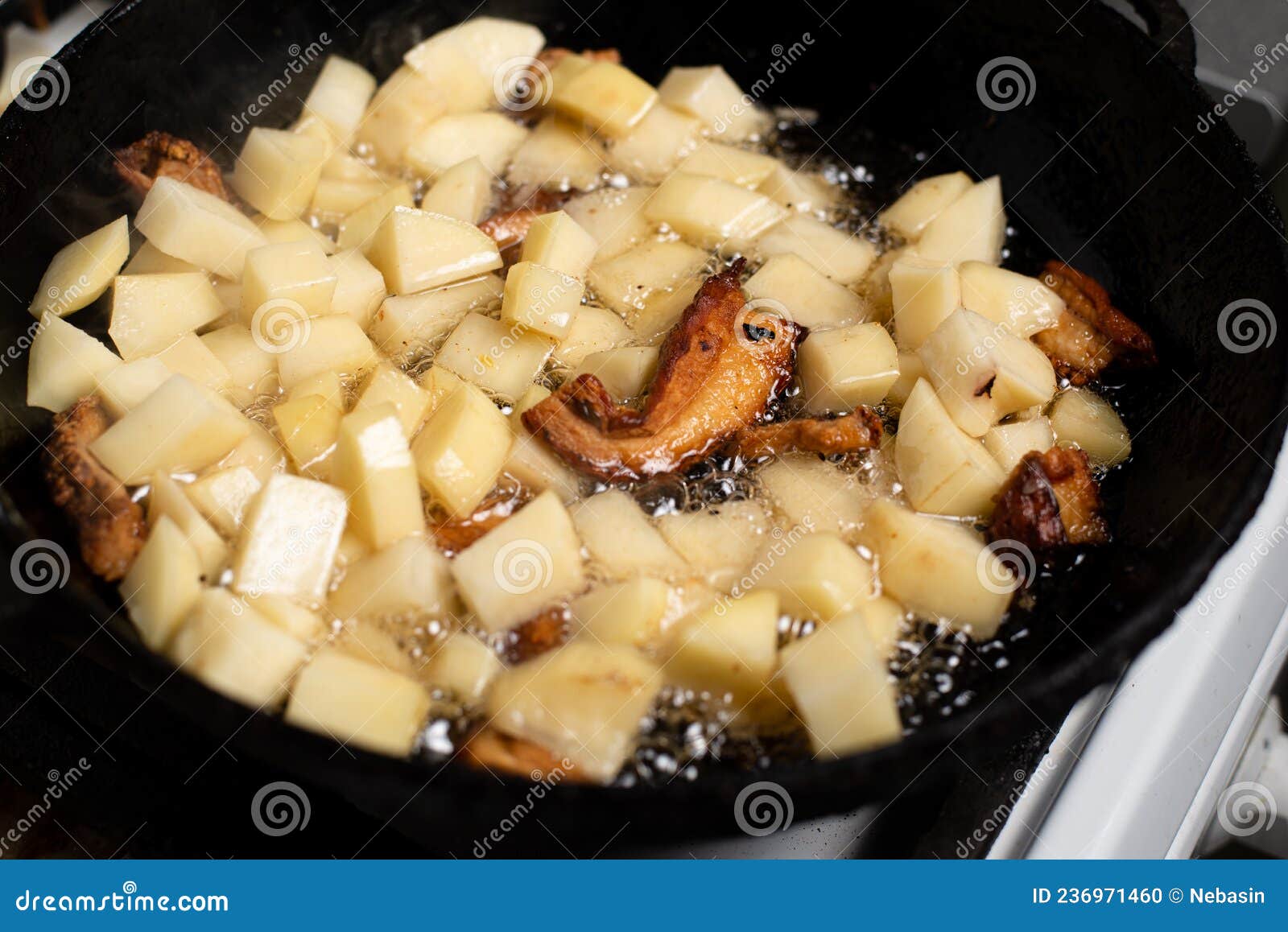 Cooking Fried Potatoes with Lard, Cracklings in a Pan Stock Photo