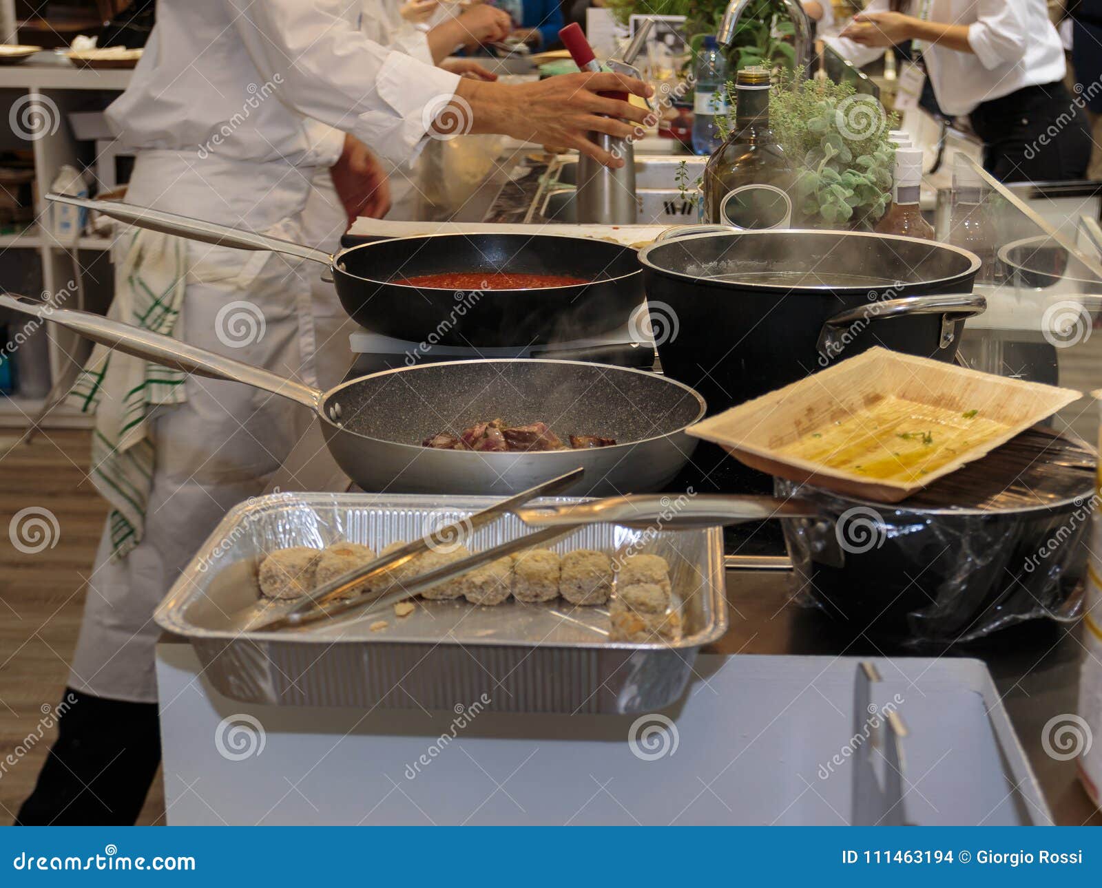 Cooking Inside Restaurant`s Kitchen, Pans and Chef with Uniform Stock