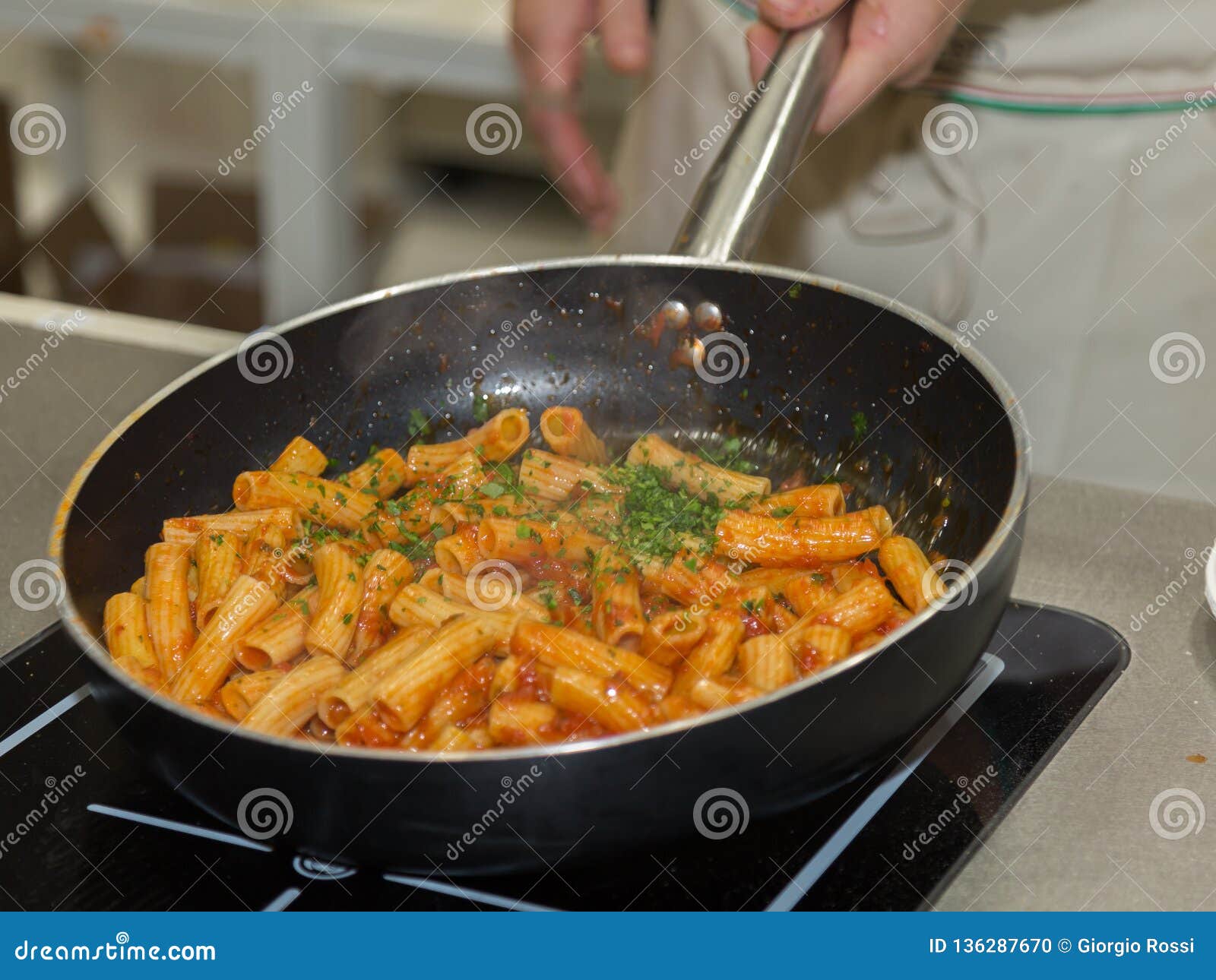 Cooking Italian Pasta Inside Saucepan Chef at Work in the Kitchen
