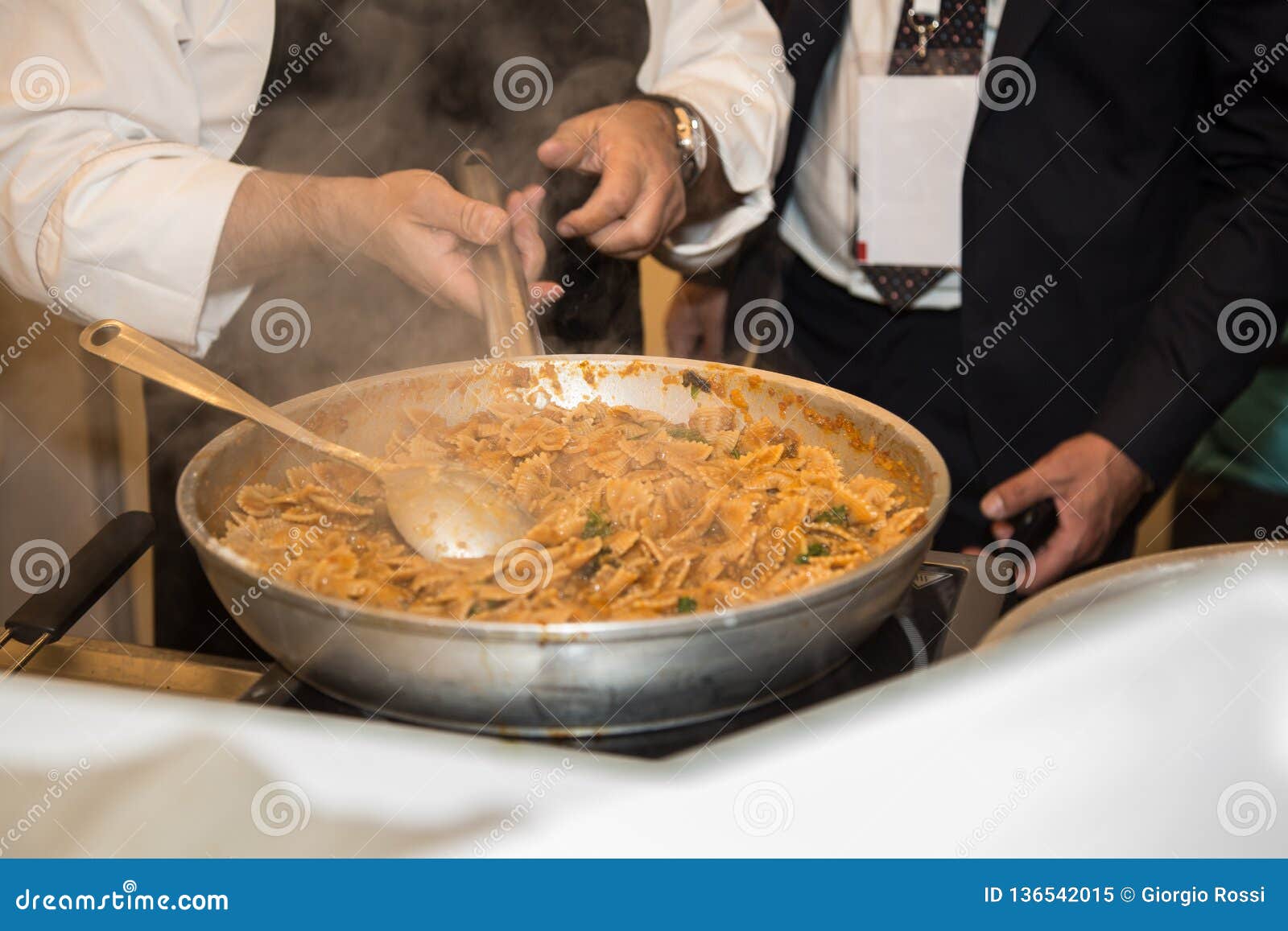 Cooking Italian Pasta Inside Saucepan Chef at Work in the Kitchen
