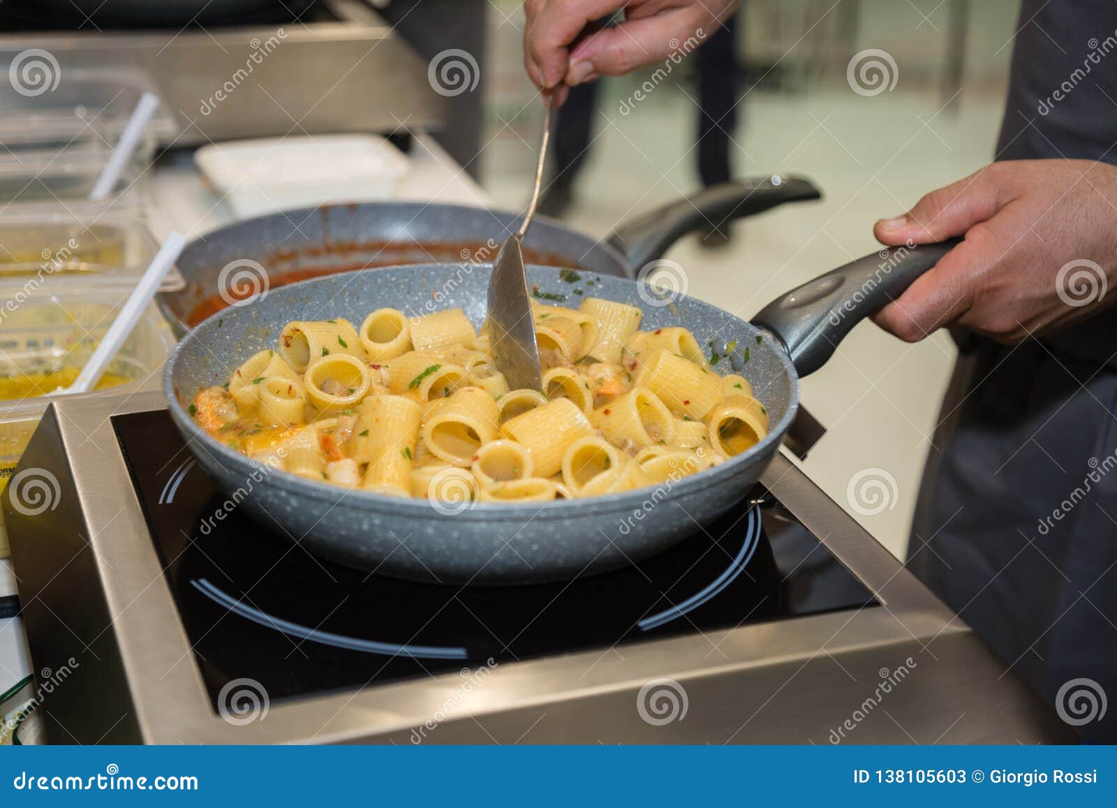 Cooking Italian Pasta Inside Saucepan Chef at Work in the Kitchen