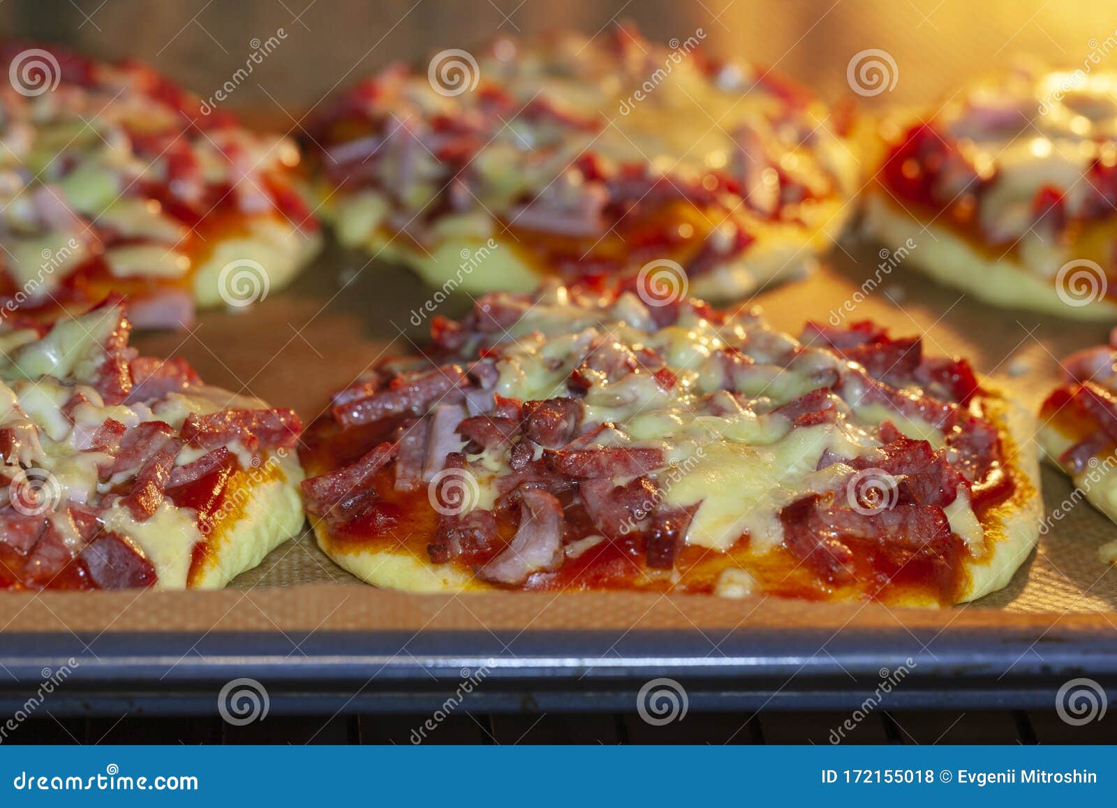 Cooking Mini Pizzas in an Electric Oven. Stock Photo Image of