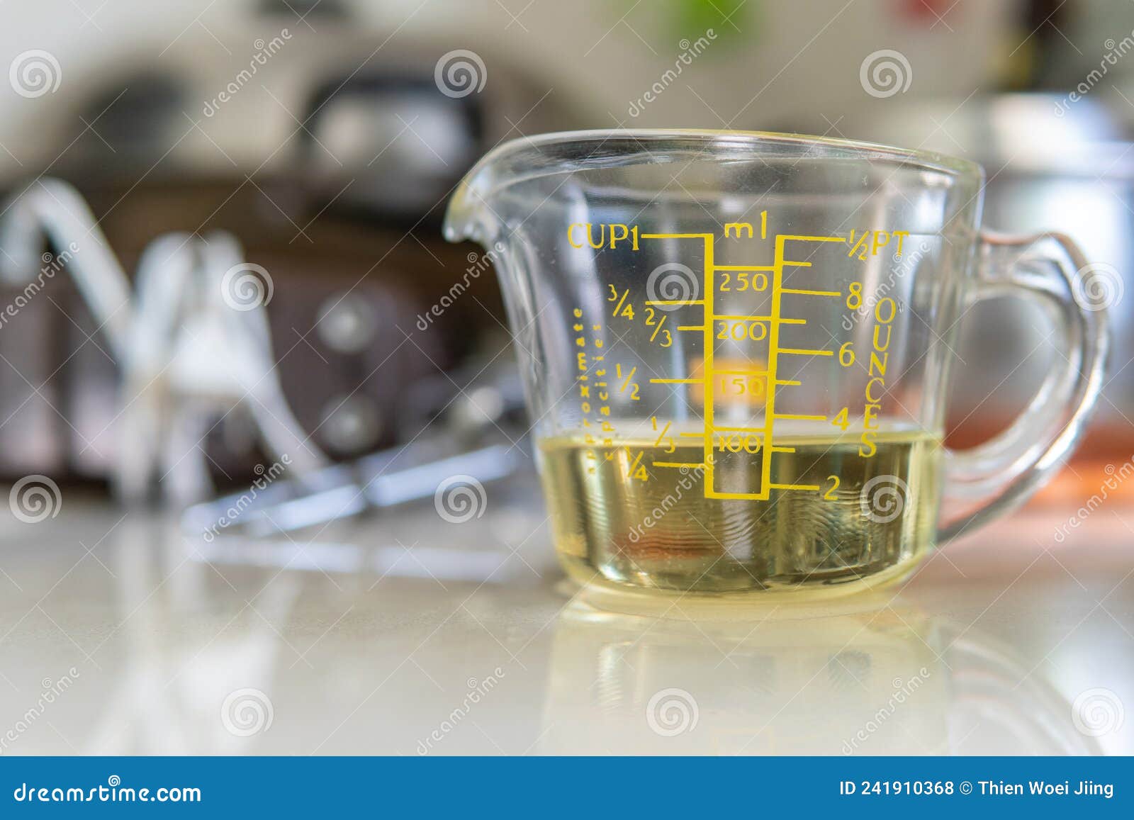 Oil in measuring cup isolated on white background Stock Photo