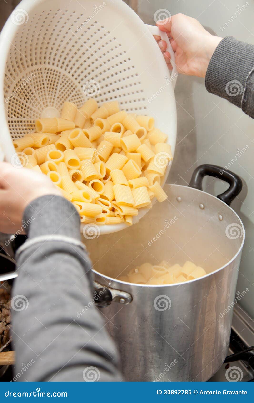 Cooking Pasta with a Colander Stock Photo Image of steel, pasta 30892786