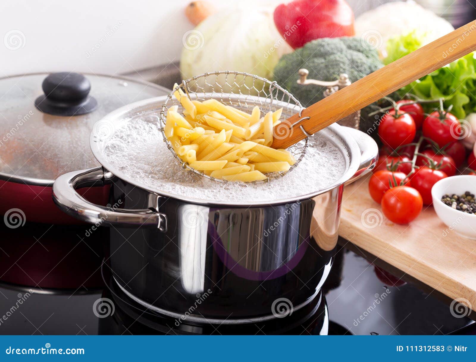 Cooking Pasta in a Pot with Boiling Water on a Cooker Stock Image