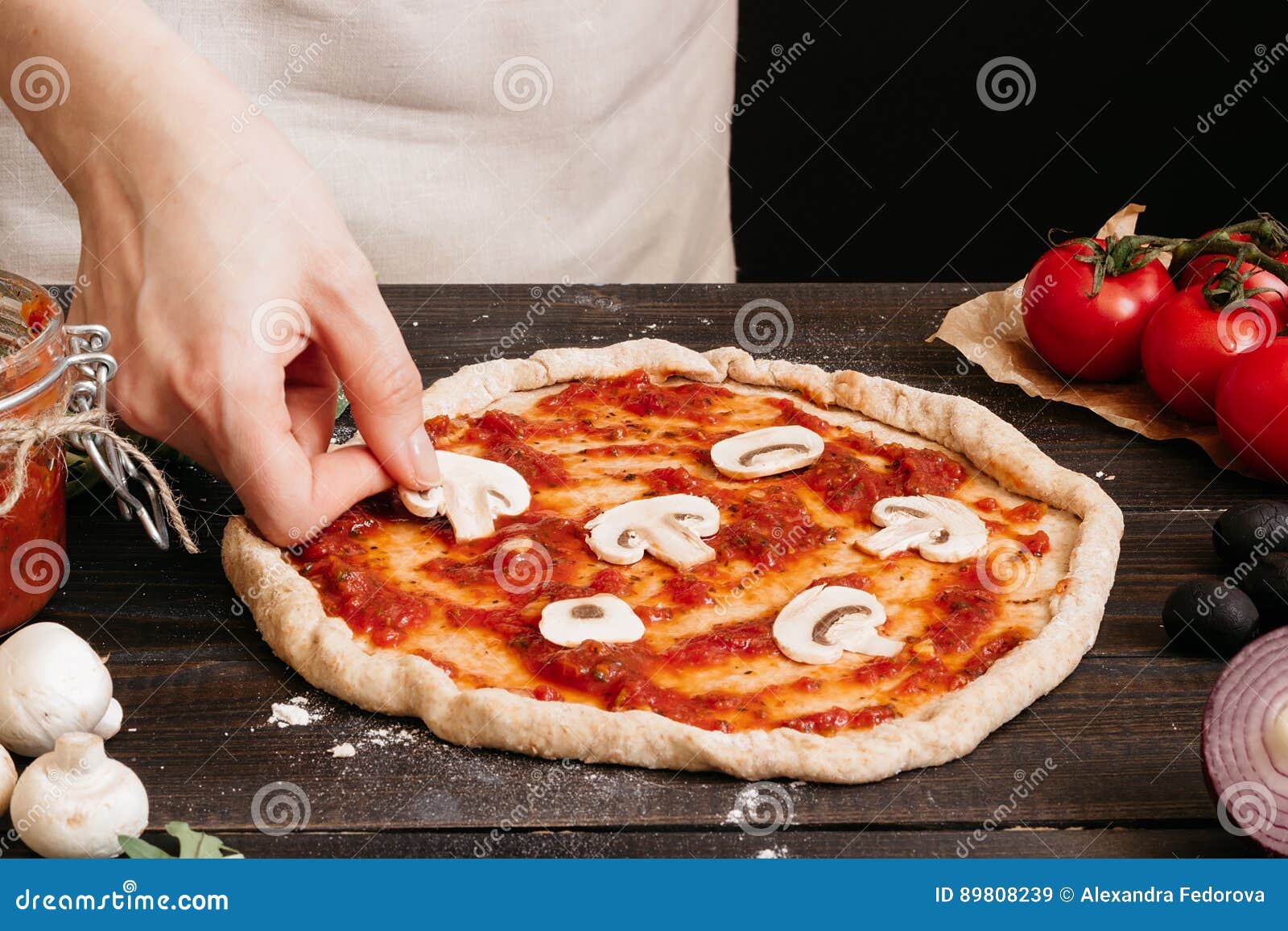 Cooking Pizza. Hands Adding Fresh Mushrooms To Pizza Stock Image