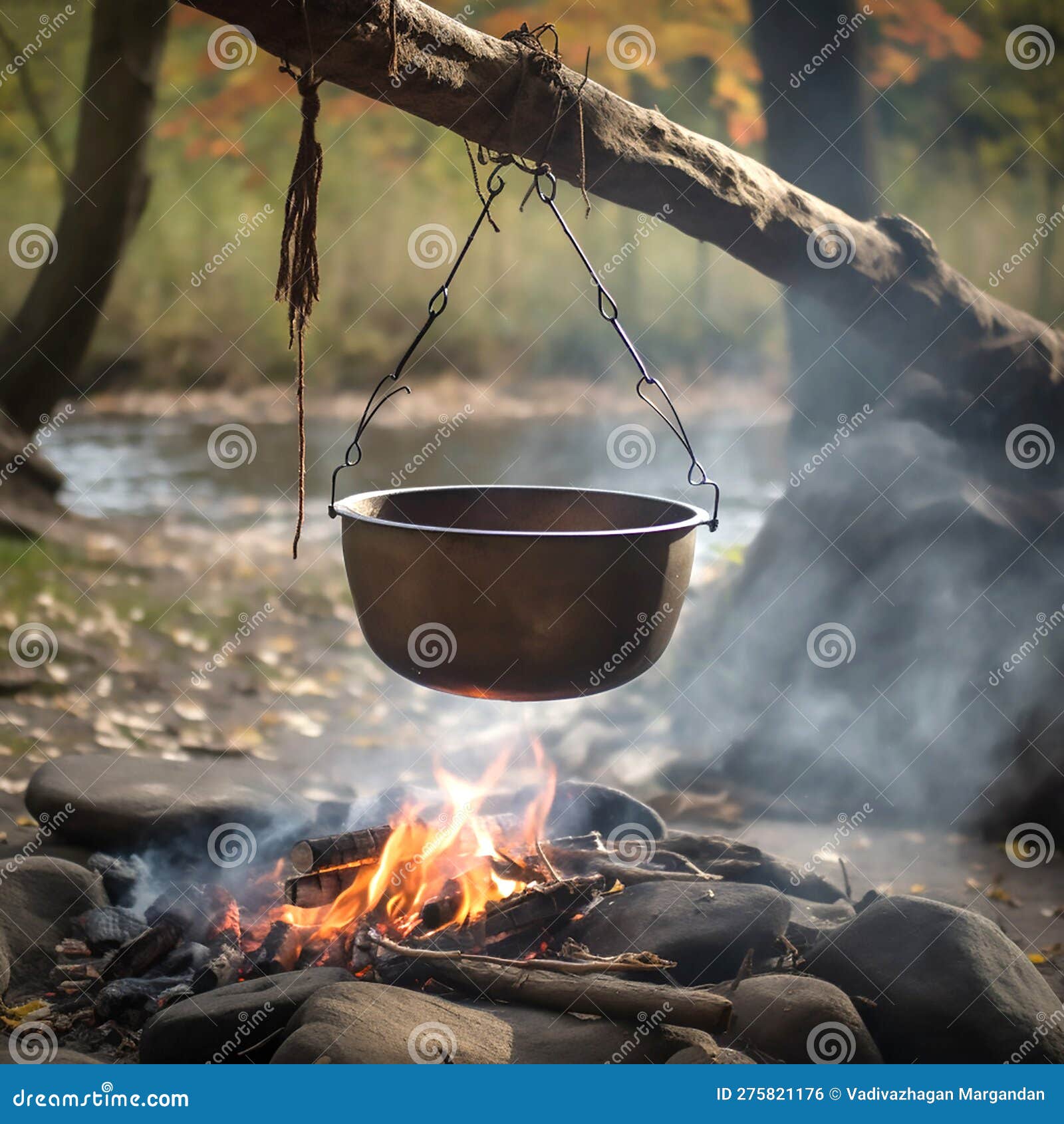 Over the fire hangs a pot in which to cook food. On a hook on a tripod,  steam comes out of the pan. Winter Camping outdoor cooking Stock Photo -  Alamy