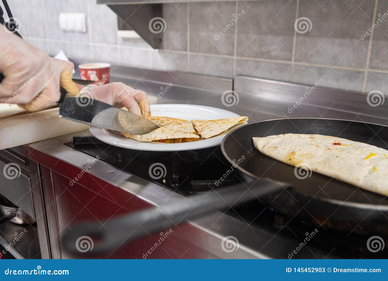 Cooking Process of Quesadilla with Pans Cook is Cutting in Pieces Stock
