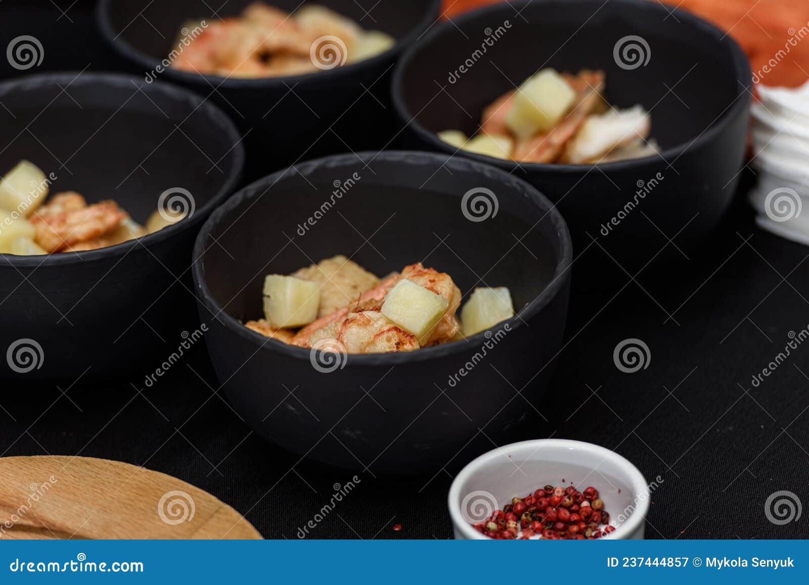 cooking process of suquet de peix soup with potatoes, herbs and fish with the addition of picada close-up in a saucepan