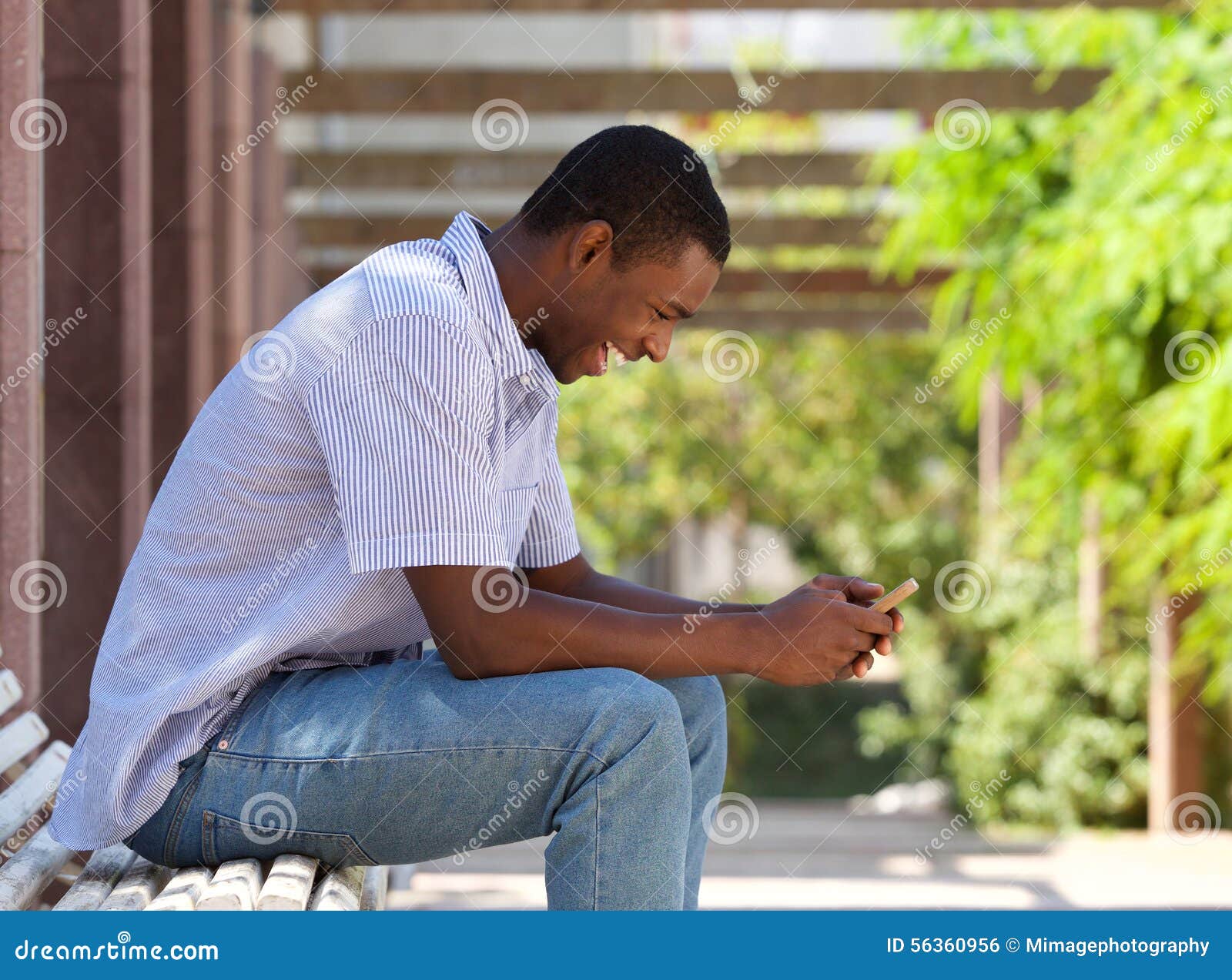 cool african american guy looking at cell phone