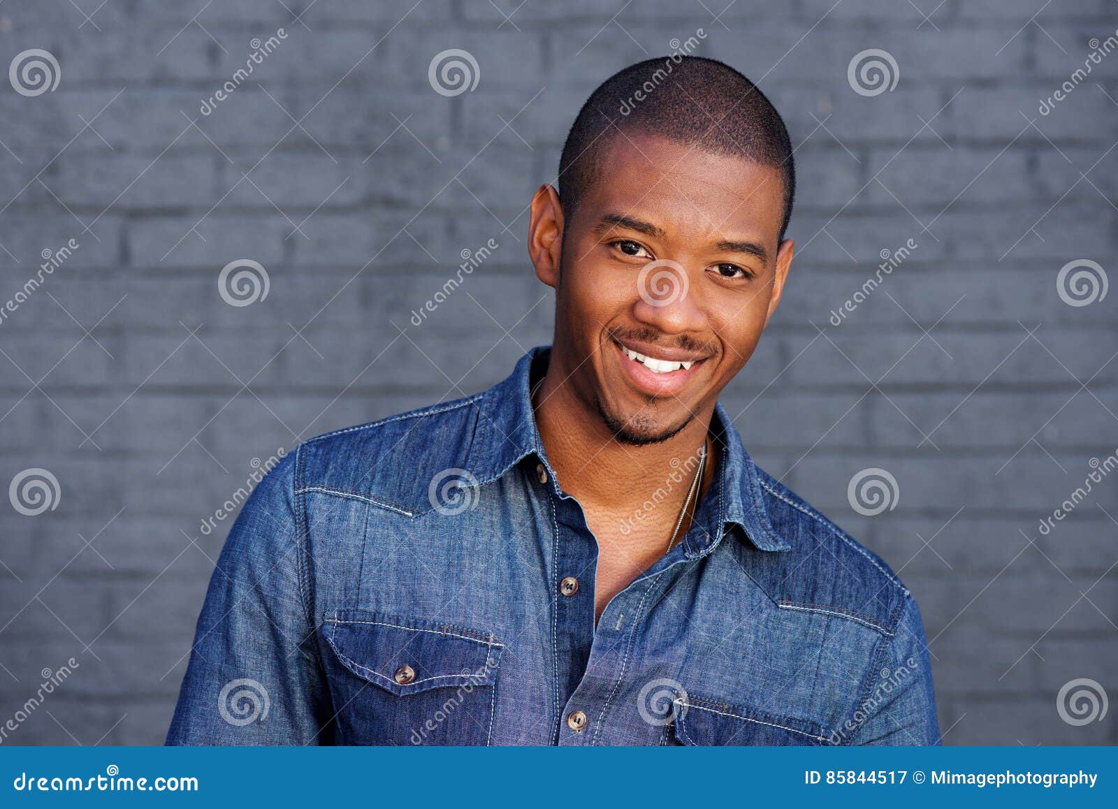 cool black guy smiling with blue shirt
