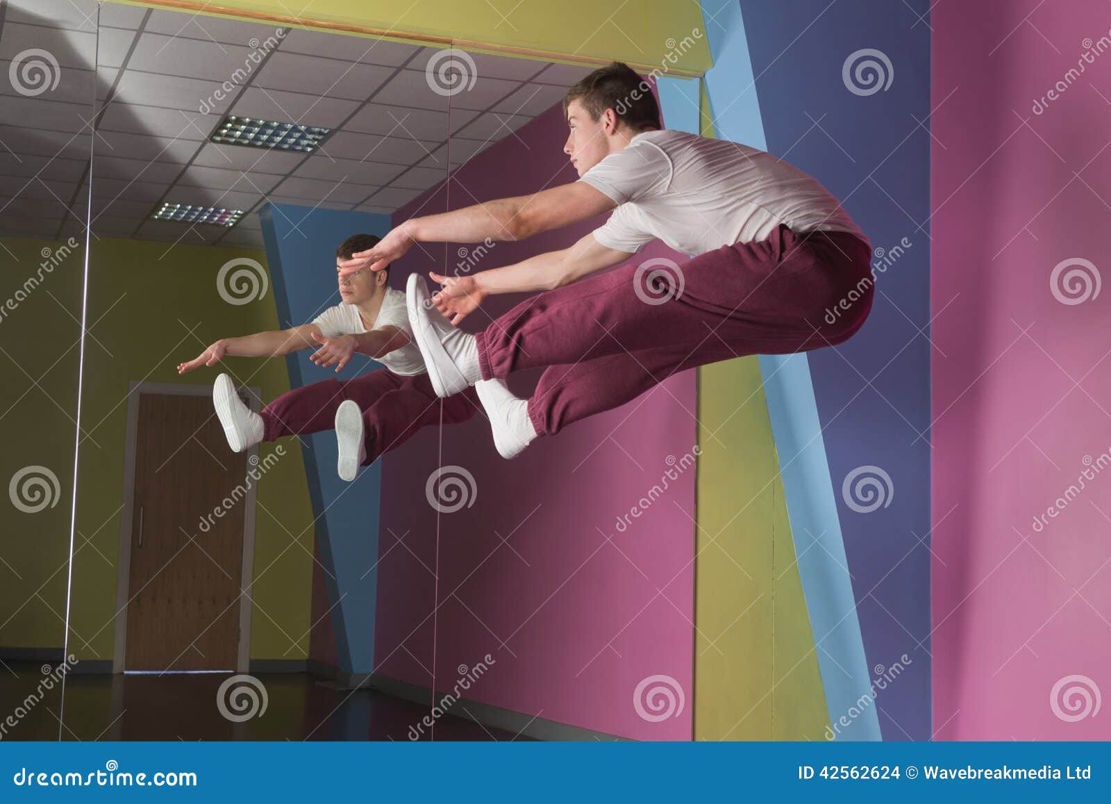 Side Splits Dance Pose By Woman Against Yellow Stock Image
