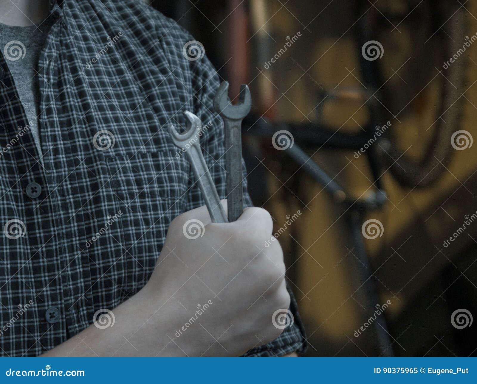 Cool Classy Young Guy is Fixing His Bicycle with Wrenches before Taking