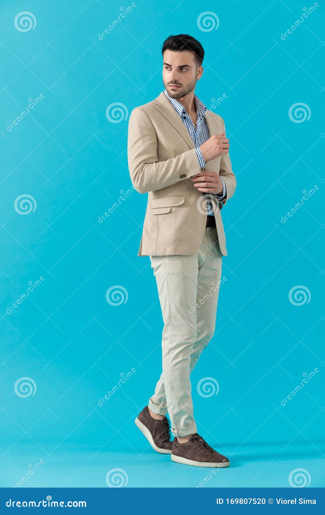 Cool Fashion Guy Adjusting Coat and Looking To Side Stock Photo - Image ...