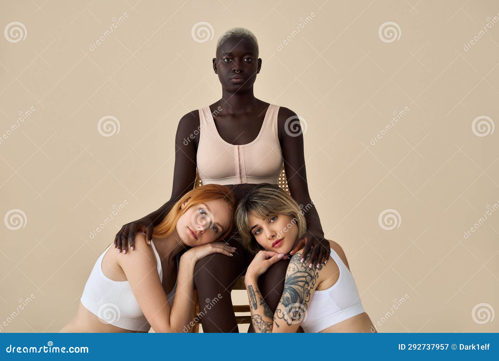 Diverse young women wear underwear sitting showing legs on beige