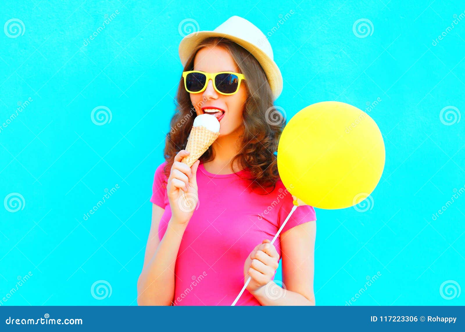 Cool Girl is Trying Ice Cream Wearing a Straw Hat and Pink T-shirt ...