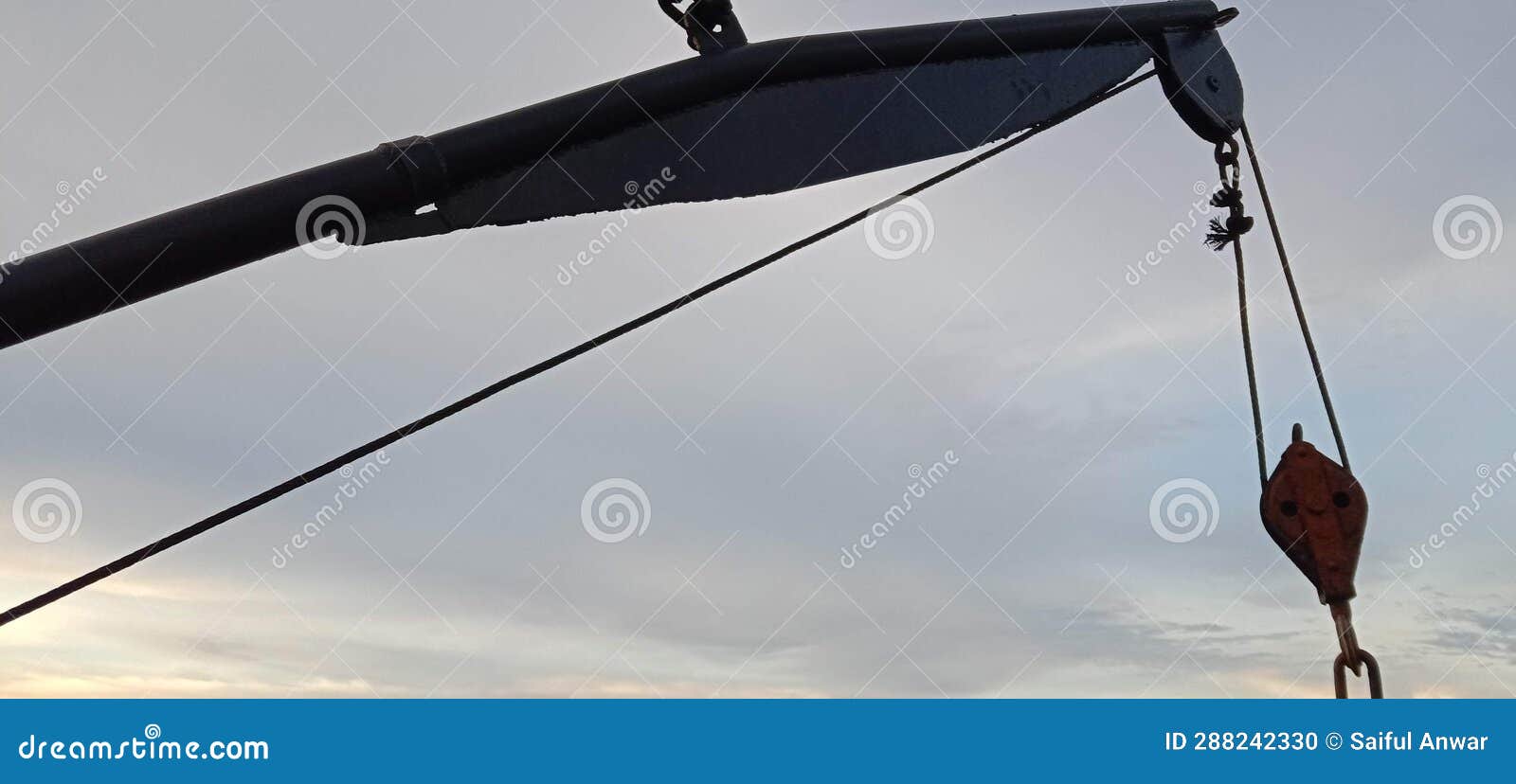 a cool overhead hanging over the boat& x27;s lifeboat rope on the ferry and visible clear sky and clouds