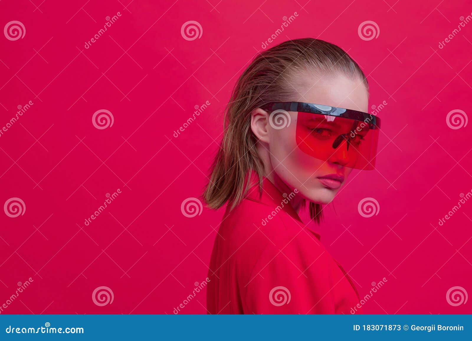 A Cool Stylish Girl with a Fashionable Hairstyle and Stylish Glasses with a  Large Glass Poses on a Bright Red Background Stock Image - Image of  colorful, girl: 183071873