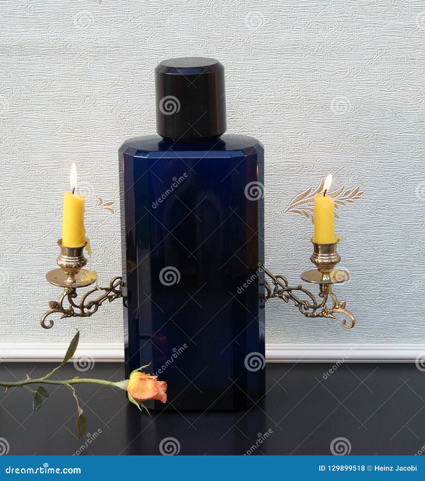 davidoff cool water, large perfume bottle in front of a piano candelabra with shining candles decorated with an english rose