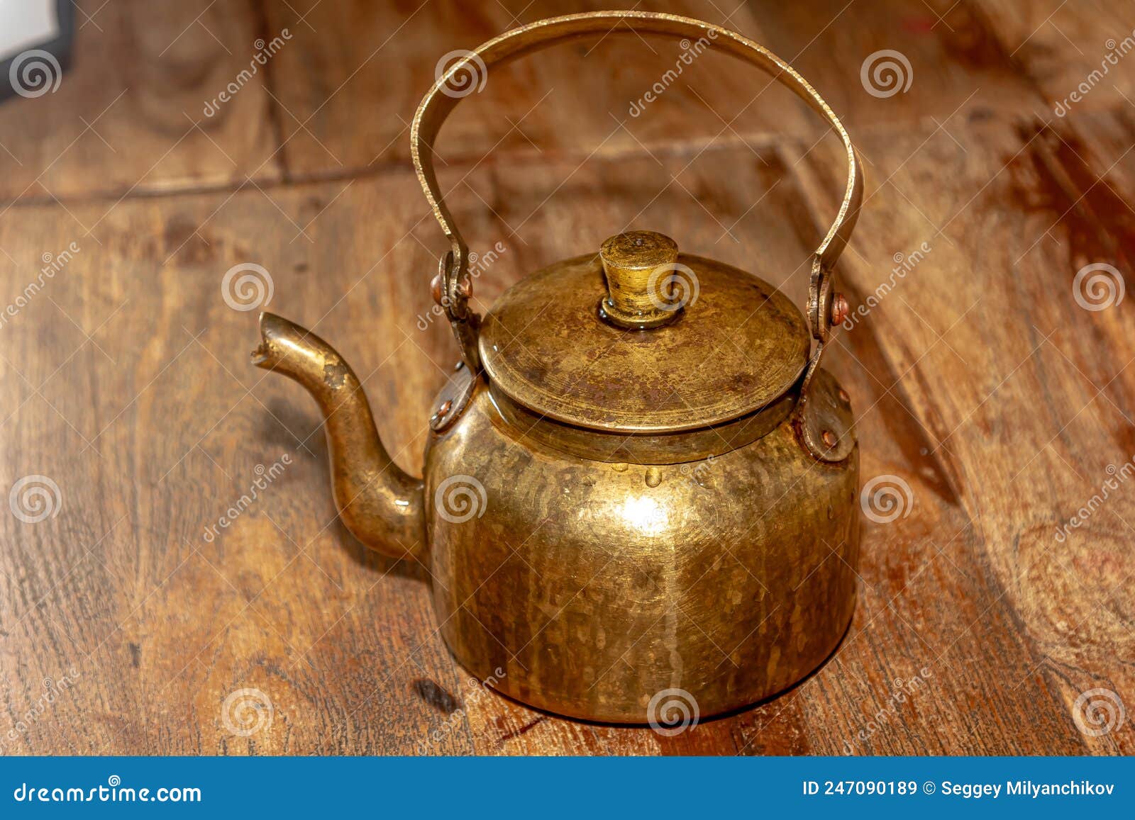Copper or Brass Kettle Stands on the Table Opposite the Gray Wall Stock