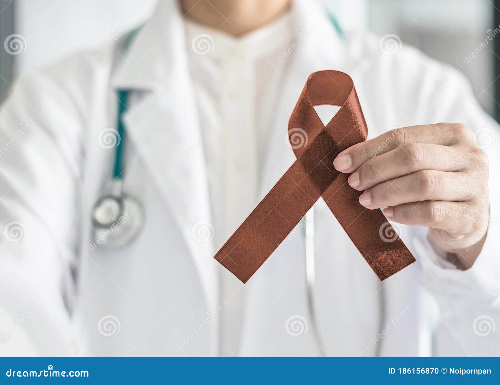 copper brown awareness ribbon on doctorÃ¢â¬â¢s hand, ic color for anti-tobacco, colon colorectal cancers, herpes simplex virus