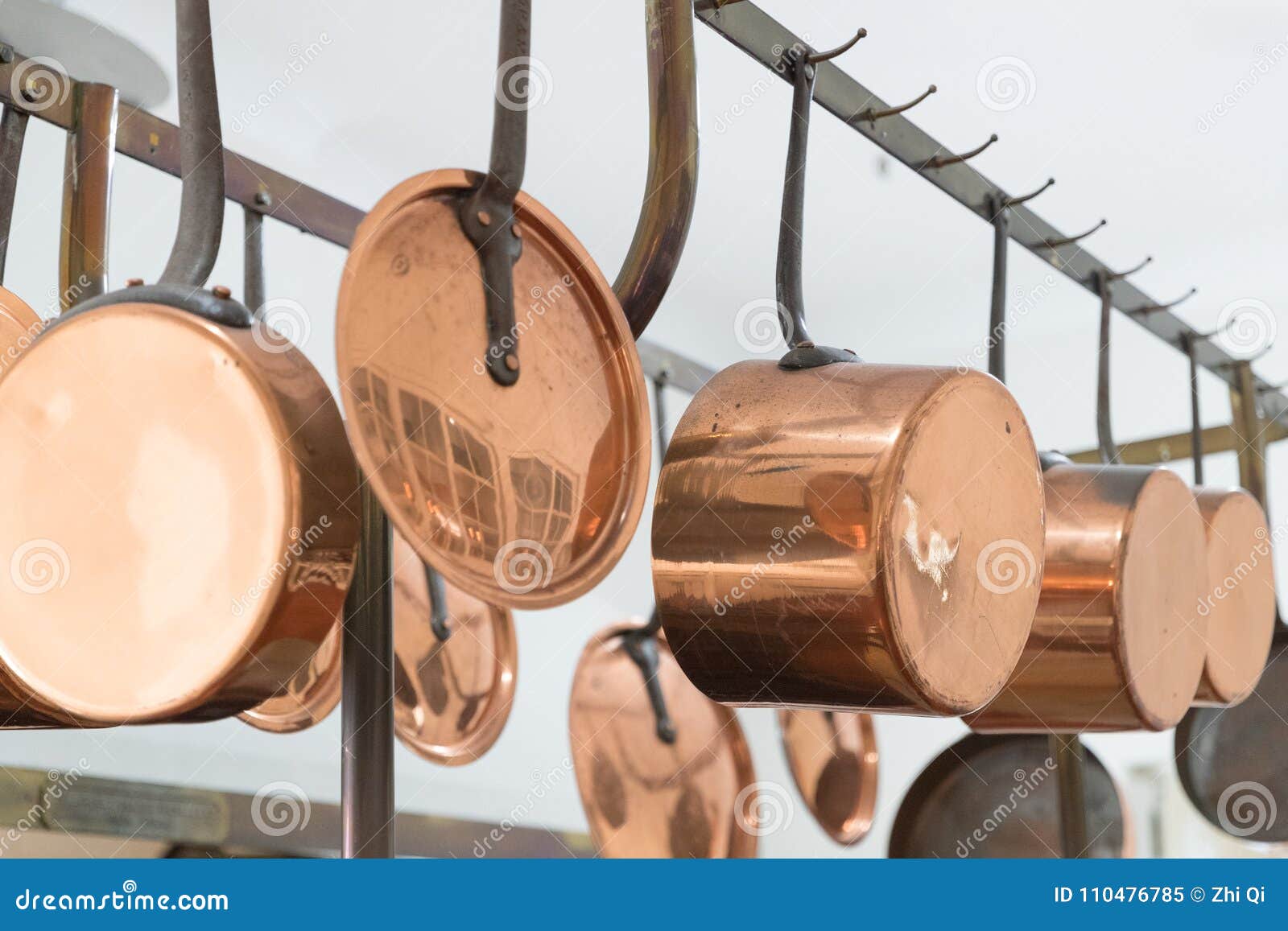 Copper Kitchenware Pots Pans Jugs Hang From The Ceiling In The