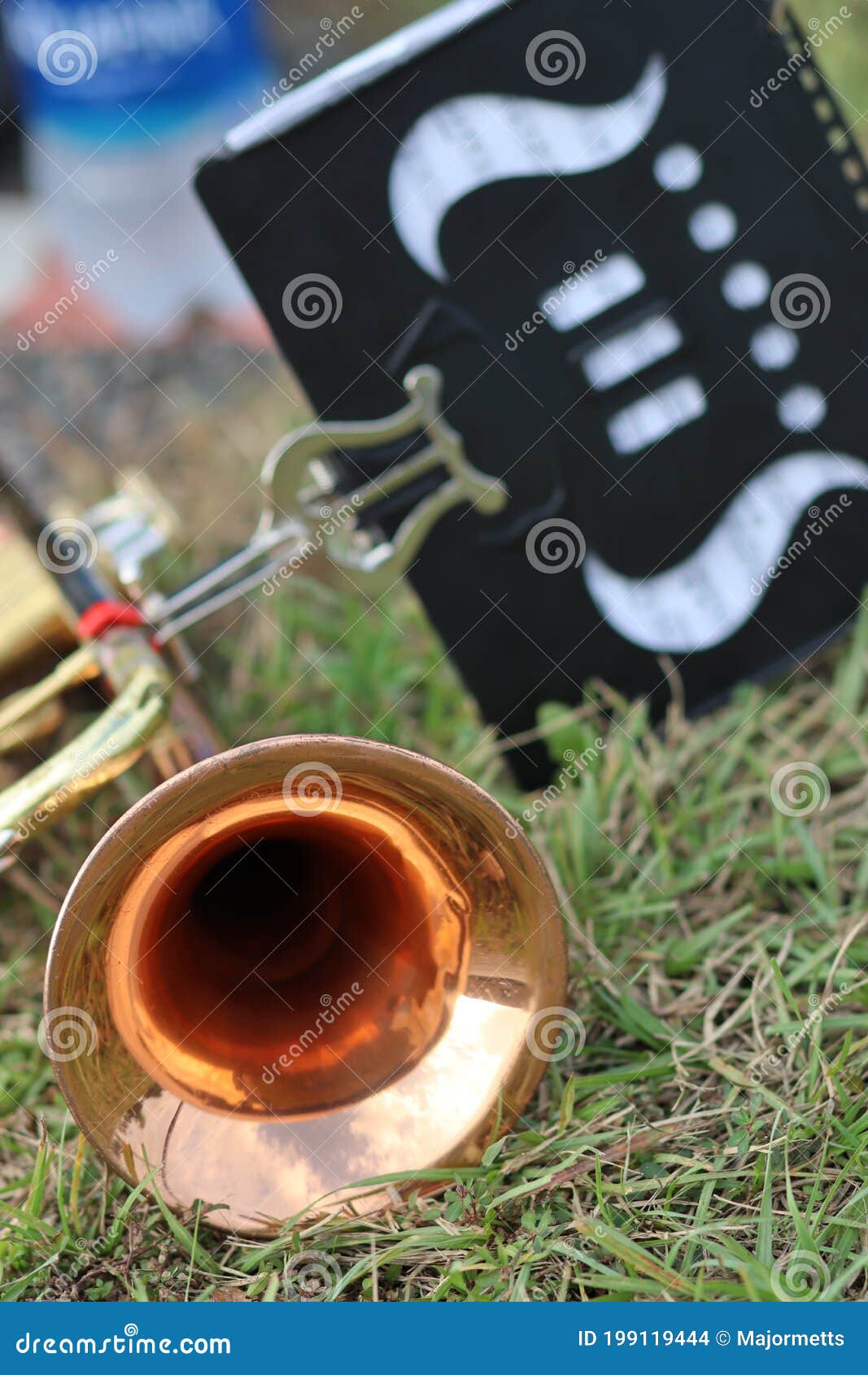 Copper Lacquer Trumpet with Lyre on Grass during Marching Band Practice