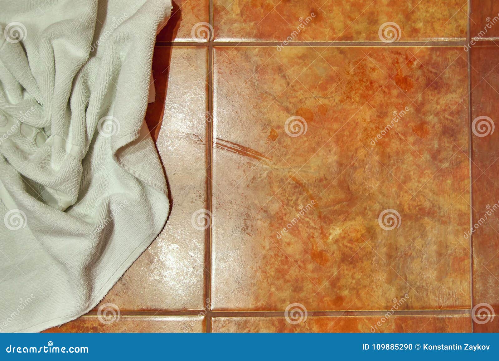 Copy Space Wet Creased White Towel On Ceramic Floor In Bathroom
