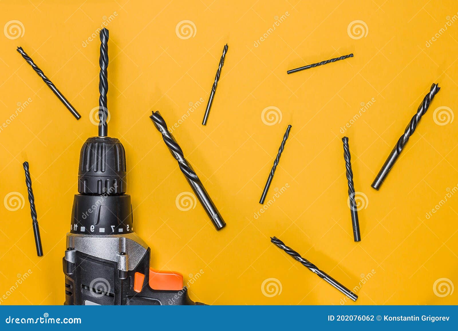 Drilling Machine with Drills of Different Lengths on Yellow Background