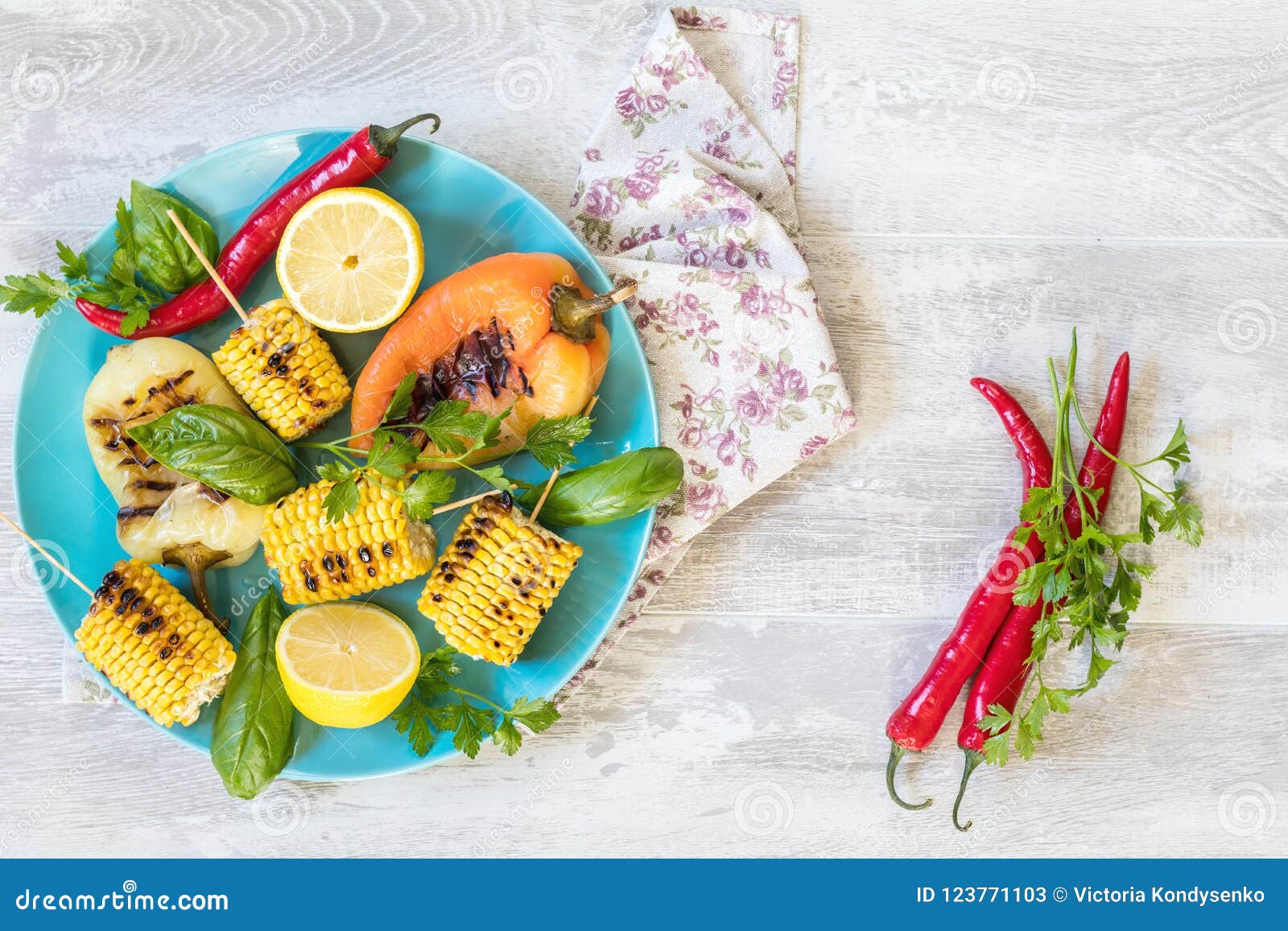 Corn Baked in Olive Oil, with Pepper, Salt and Basil on Blue Dis Stock