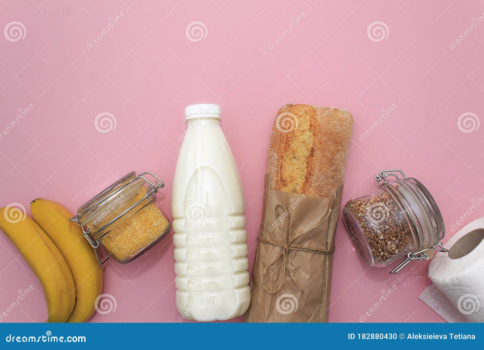 corn, buckwheat, bananas, milk, bread in white bag on blue background