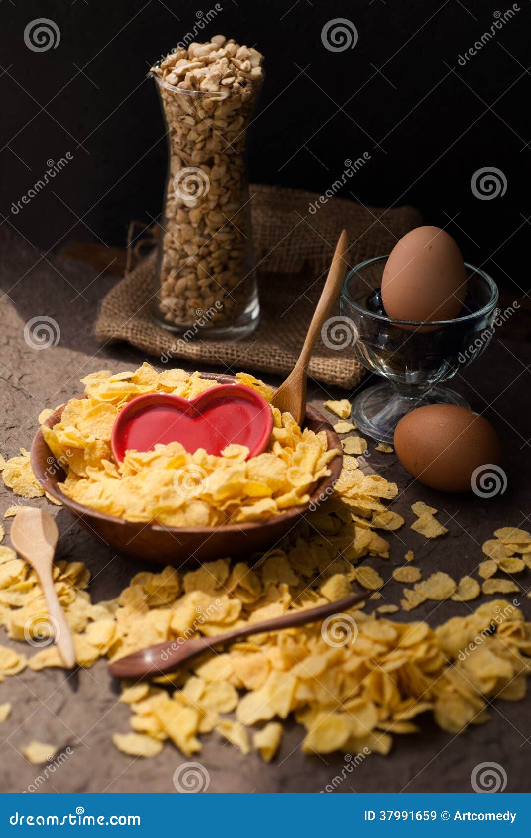 Corn Flakes in Wooden Bowl with Spoons and Red Heart Stock Image