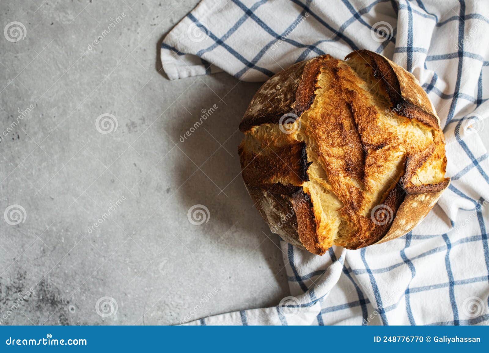 Corn Flour Sourdough Bread on a Napkin on a Gray Background. Copy Space