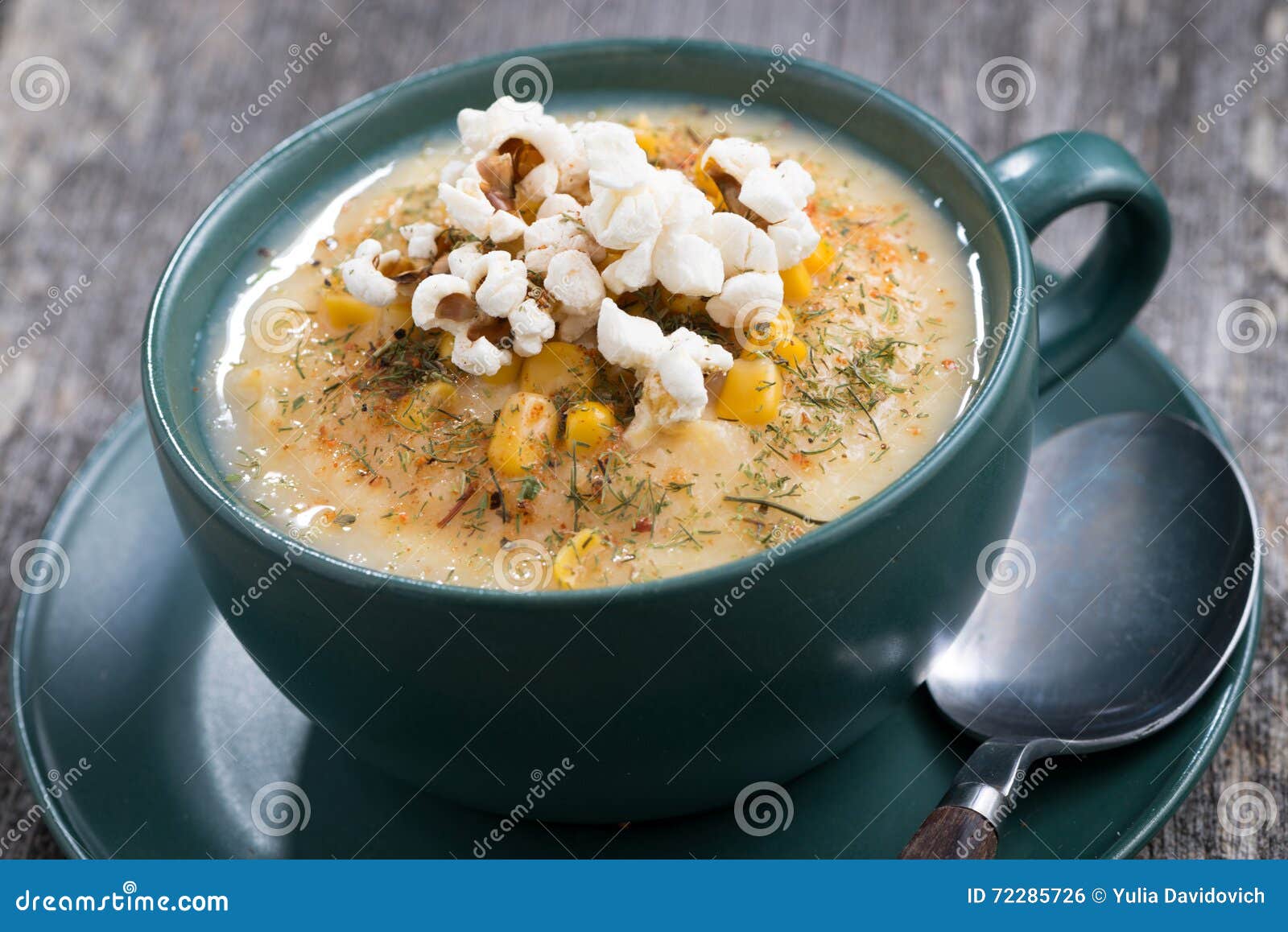 Corn Soup with Popcorn in Ceramic Cup on Wooden Table, Closeup Stock