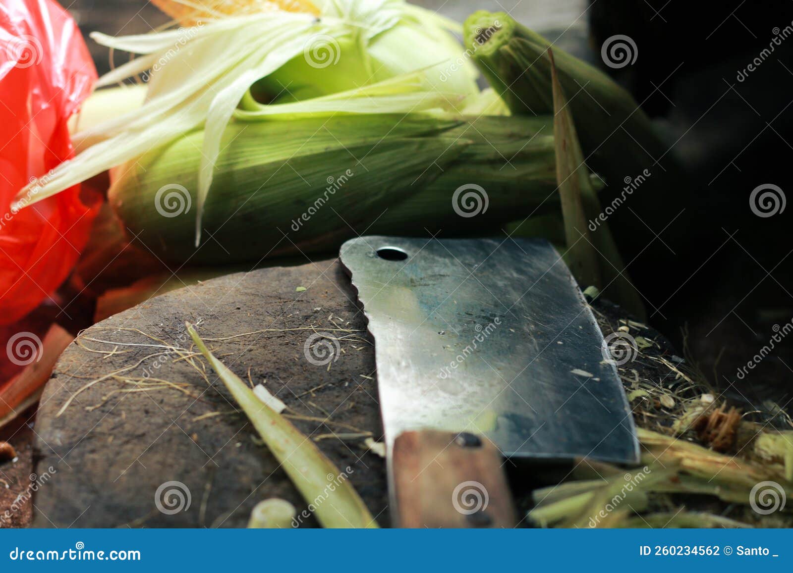 Corn, a Wooden Placemat and a Knife for Cutting Corn and Peeling Corn