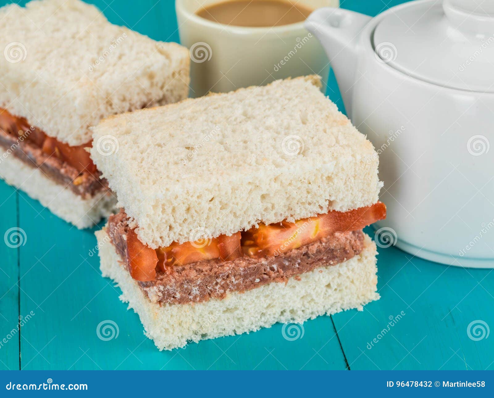 Corned Beef and Tomato White Bread Sandwich with a Pot of Hot Tea Stock