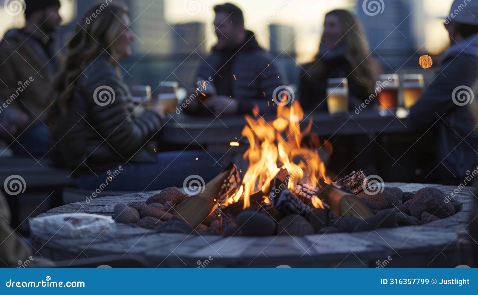 in the corner a crackling fire pit warms the cool rooftop air as partygoers gather around sipping on tails and gazing at