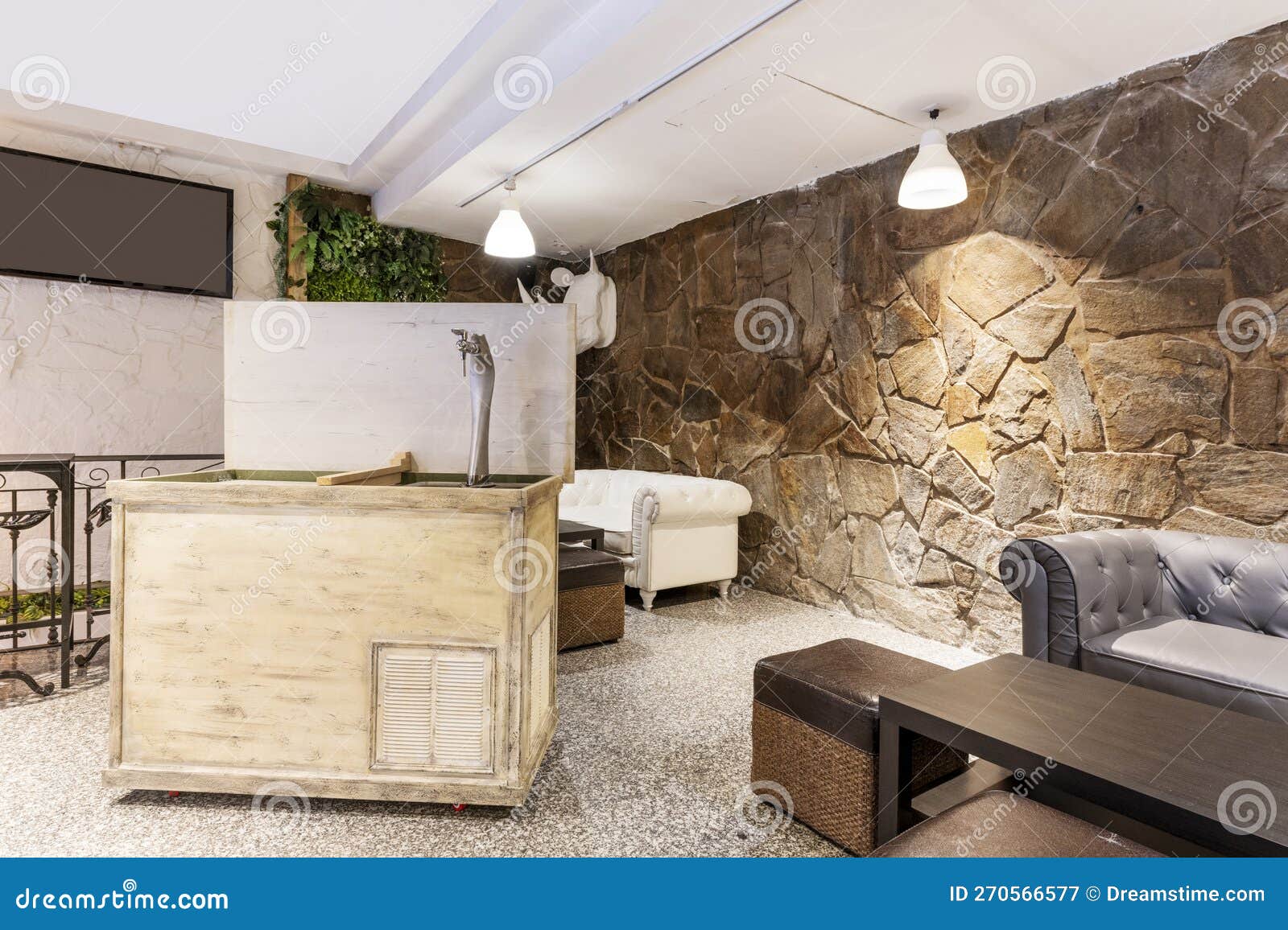 Corner of a Local with a with a Beer Tap on Wheels and Chester Style Sofas of Various