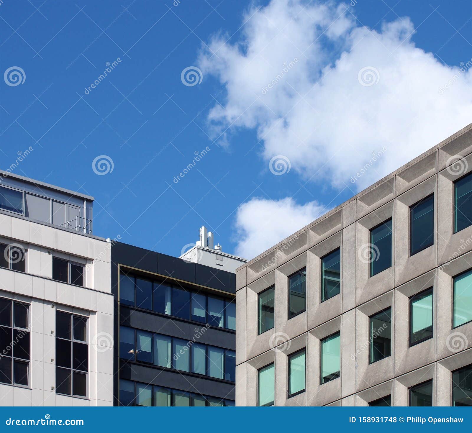 Corner View of a Group of Modern Office Buildings Against a Blue Sky ...