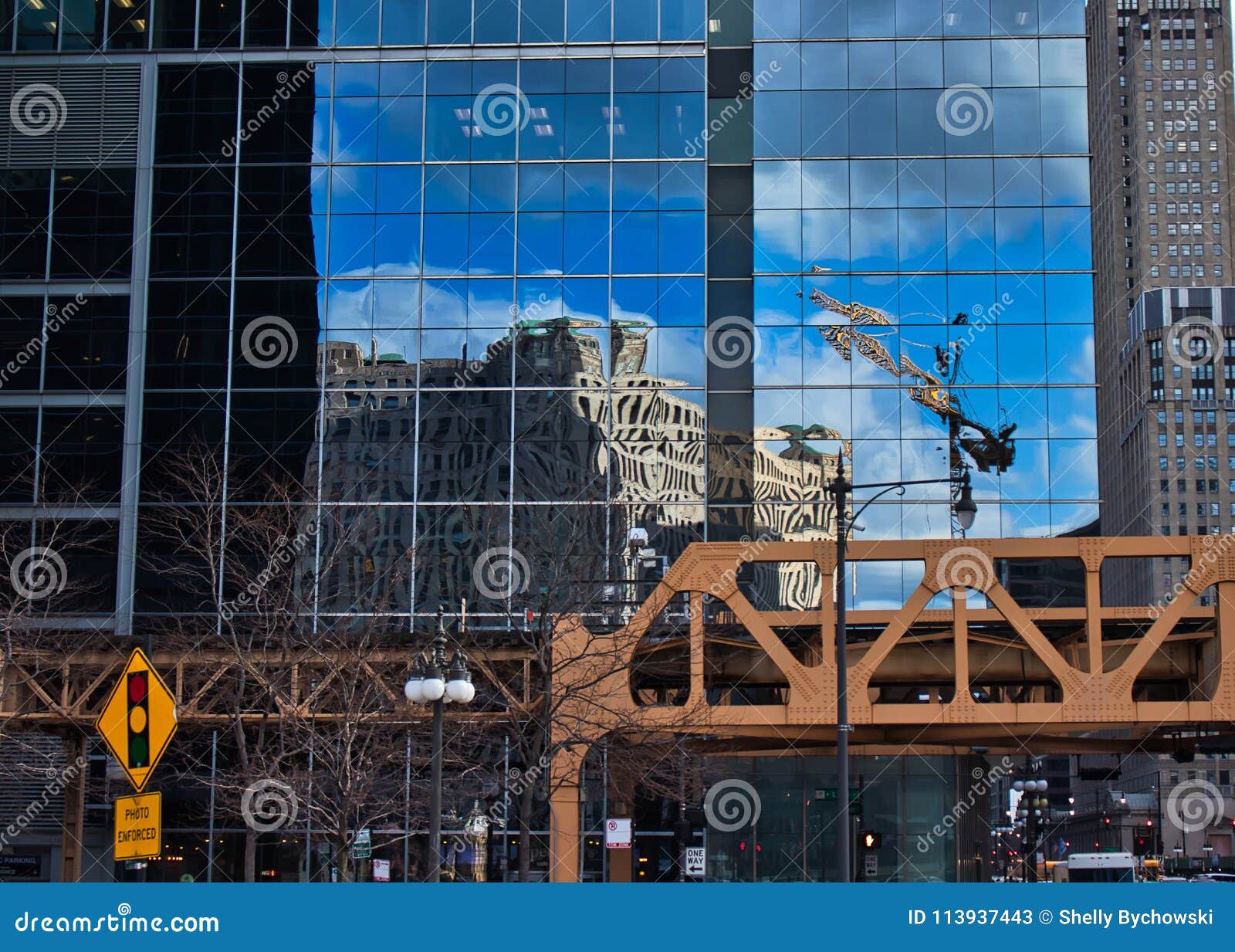 corner of wacker drive and lake street in chicago loop, with merchandise mart reflected in a mirrored building exterior, and photo