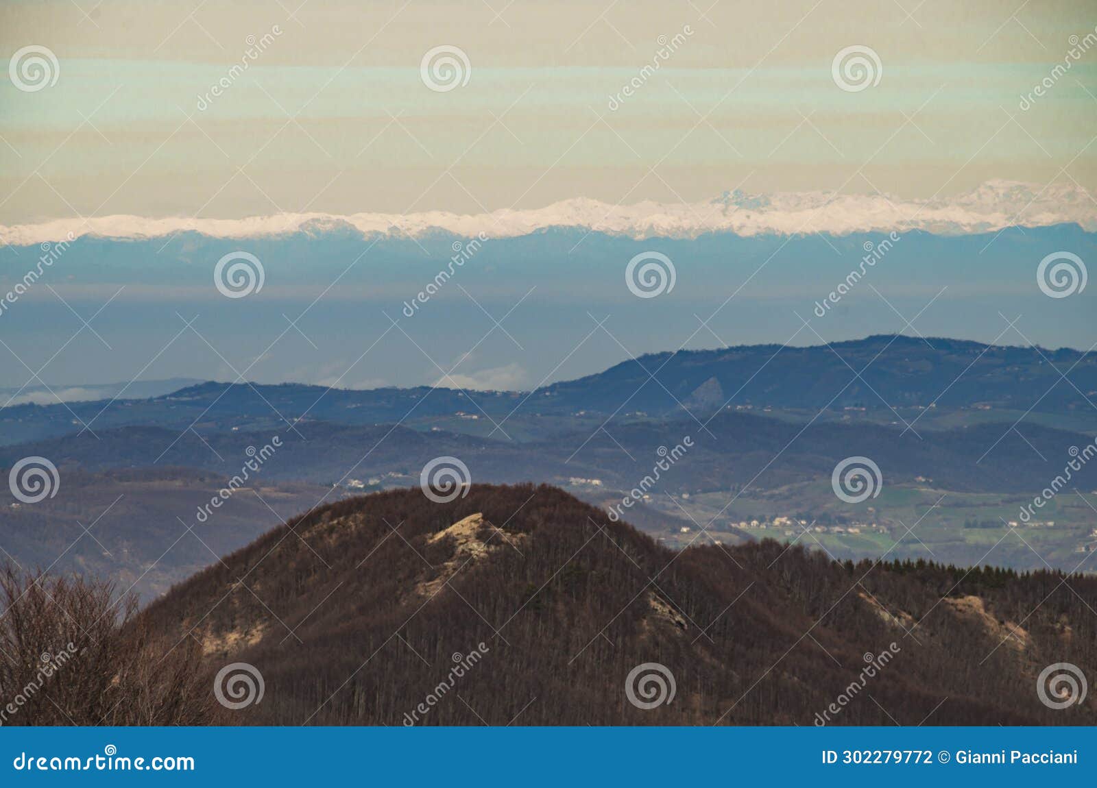 view of the panaro valley in winter with a view to the horizon of the alps