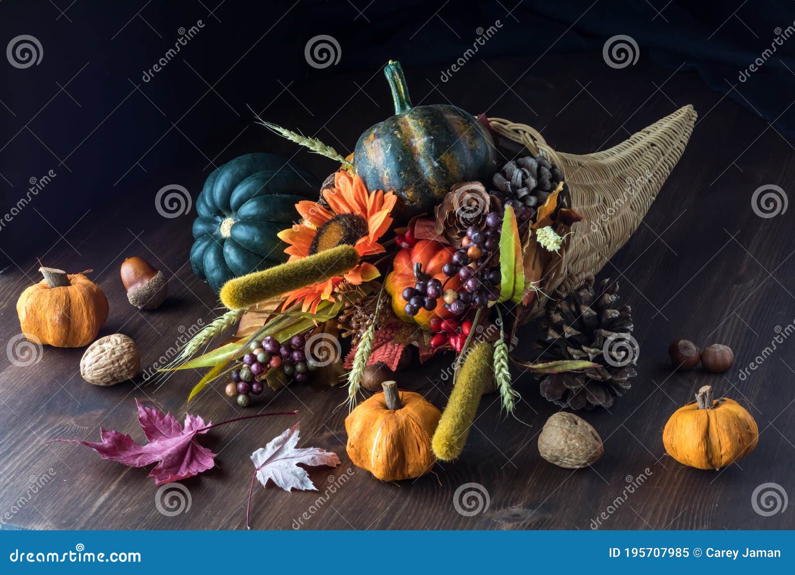 cornucopia centrepiece filled with autumn decorations against a black background.